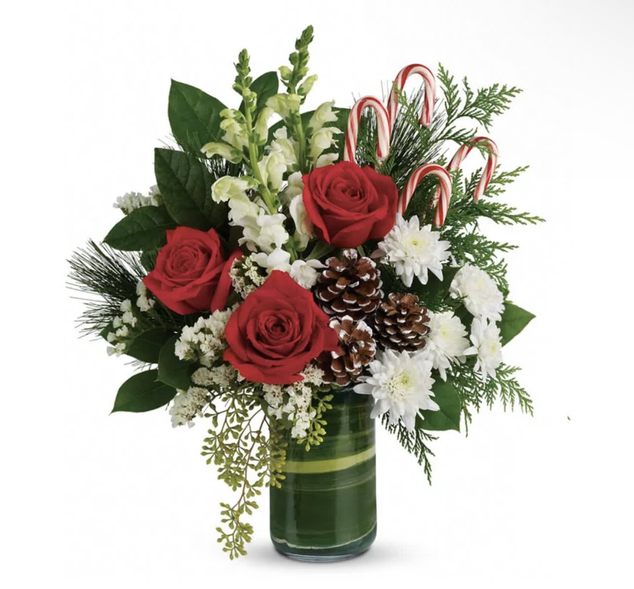 Christmas Red, Green &amp; Candy Cane - Send holiday greetings with this bouquet of red roses, white snapdragons, and more! Decorated with 4 candy canes to get everyone into the holiday spirit, your recipient will love this arrangement! This luxury Christmas arrangement is a stunning gift to send to someone special to you this holiday.   PLEASE NOTE: Florist reserves the right to make modifications to the design based on seasonality and accessibility of blooms and vases. Any modifications made will honor the palette, intent, and feeling of the pictured design. Contact floral designer directly with any specifications or concerns.