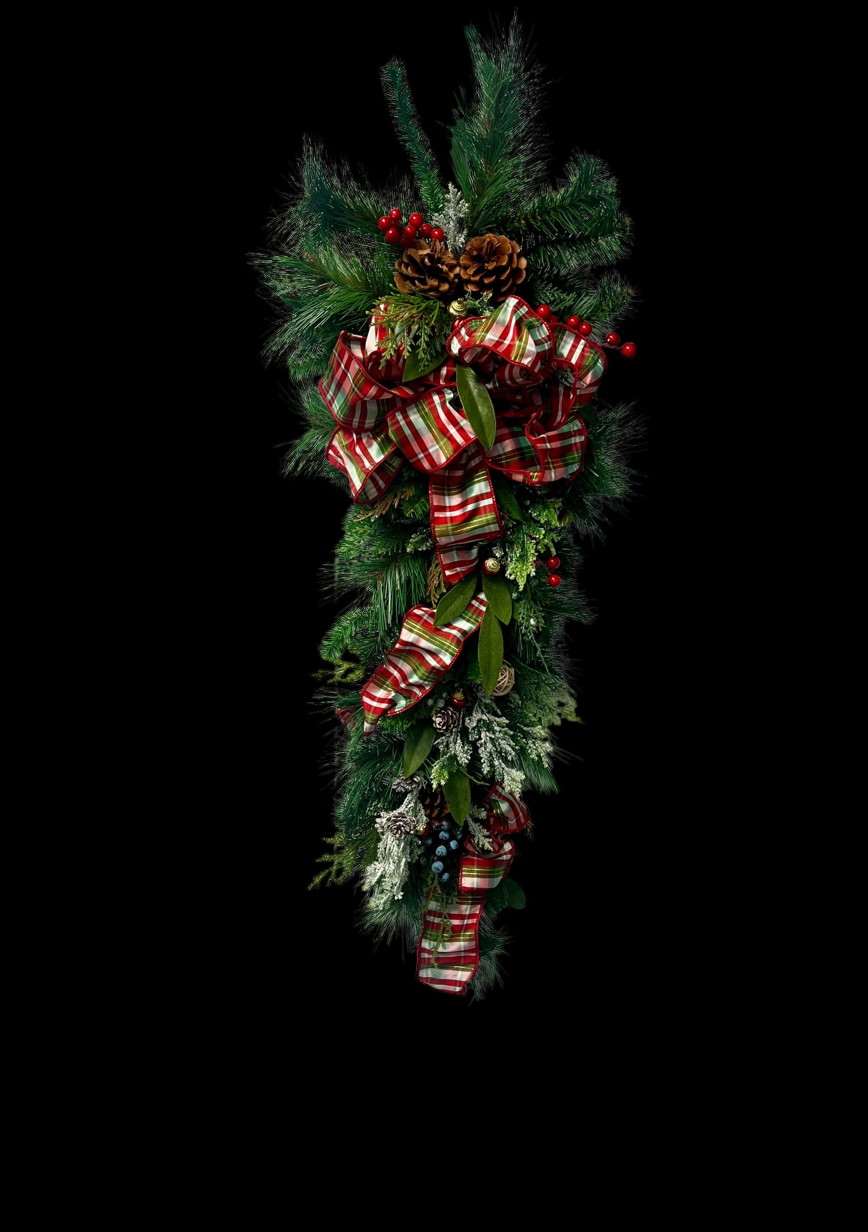 Holiday Hanging Teardrop - Celebrate the season with this stunning holiday teardrop swag, featuring lush greenery, vibrant berries, pinecones, and a festive plaid bow. Perfect for adding elegance to your front door or mantle.10” 3.2 feet