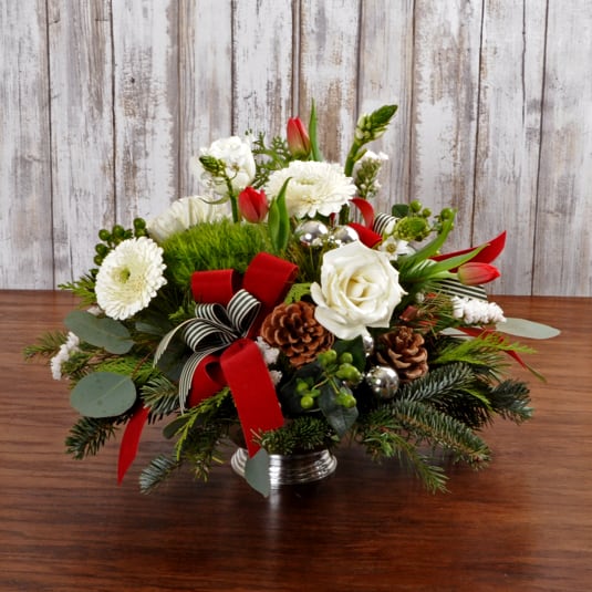 Jingle Bells Centerpiece - Rounded classic style holiday centerpiece with a festive mix of premium flowers and evergreens.