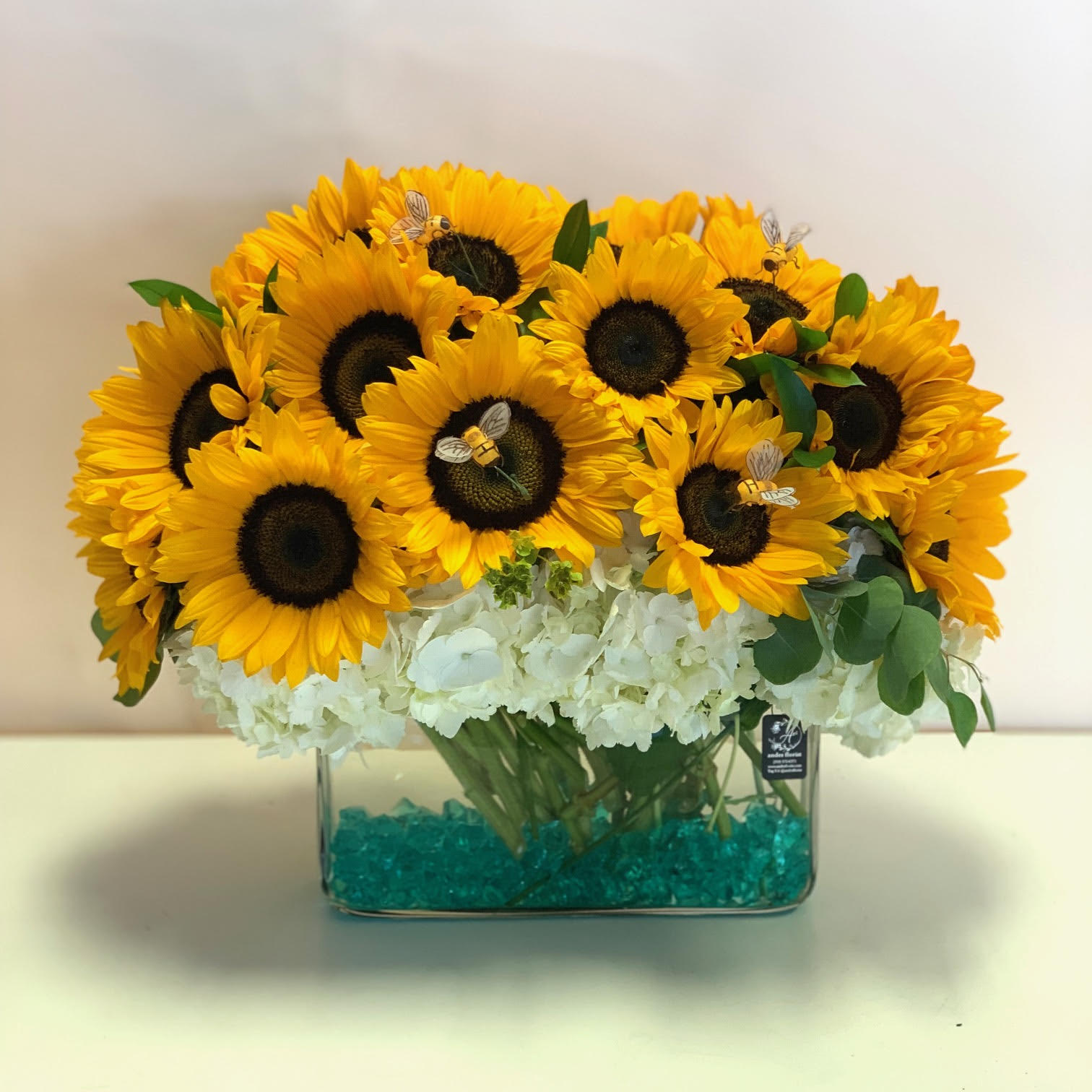 Lizz and the Bees - Grand Sunflowers, Hydrangea, and Greens! - This grand sunflower bouquet will have you feeling like it's summer all year round! Different kinds of green accents and crystals will give these yellow beauties a classy touch.