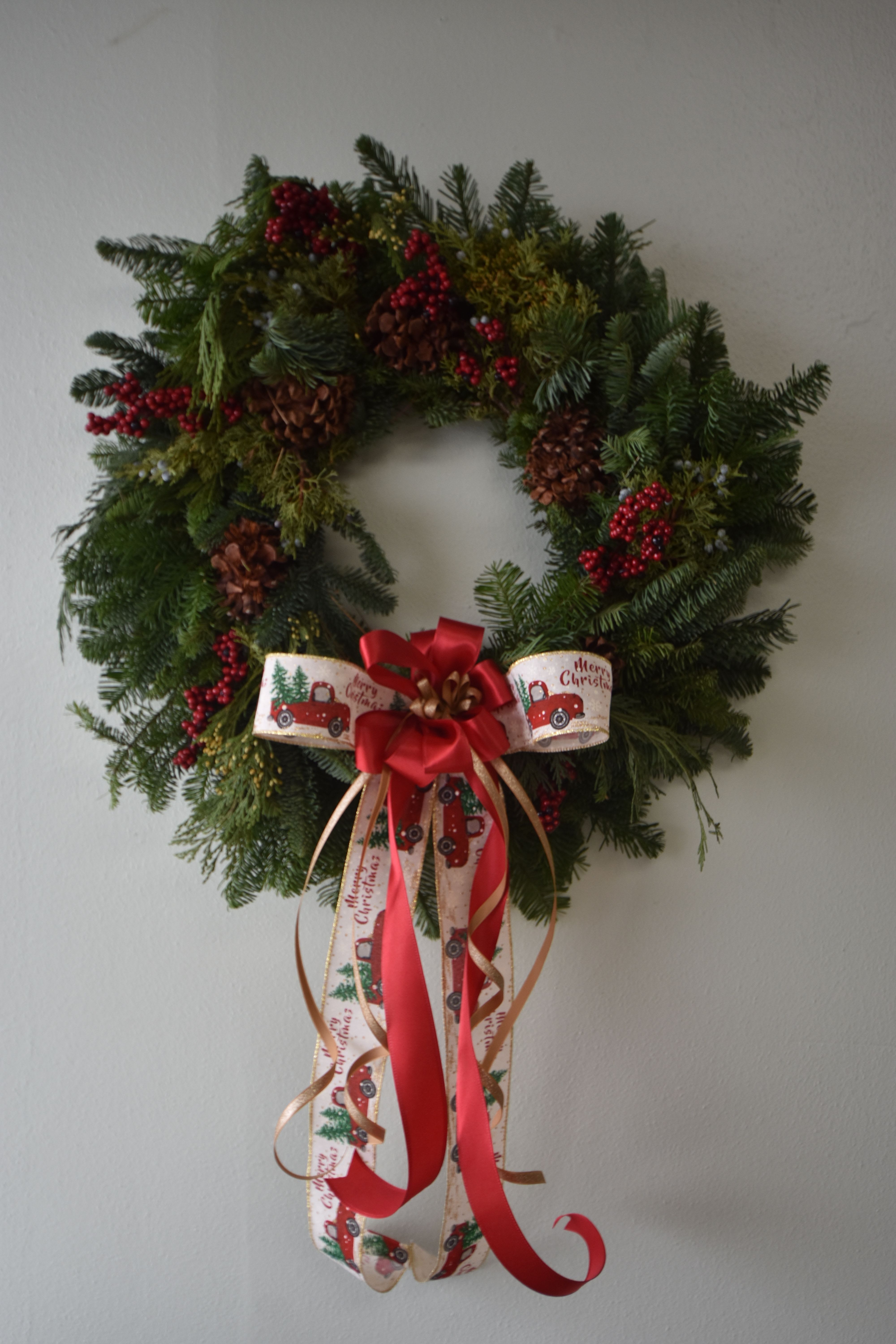 Merry and Bright Christmas Wreath - Real pine Christmas wreath with pinecones and berries with festive bow details.