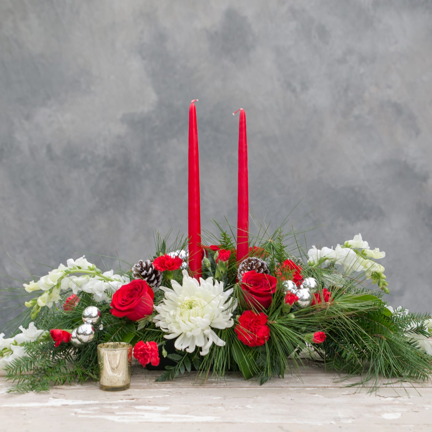 Traditional Holiday Centerpiece, Long and Low - The beauty of Christmas for your dining room table! Traditional reds, whites and greens accented with pine cones and  ornaments. Perfect for a table seating 8 or more.