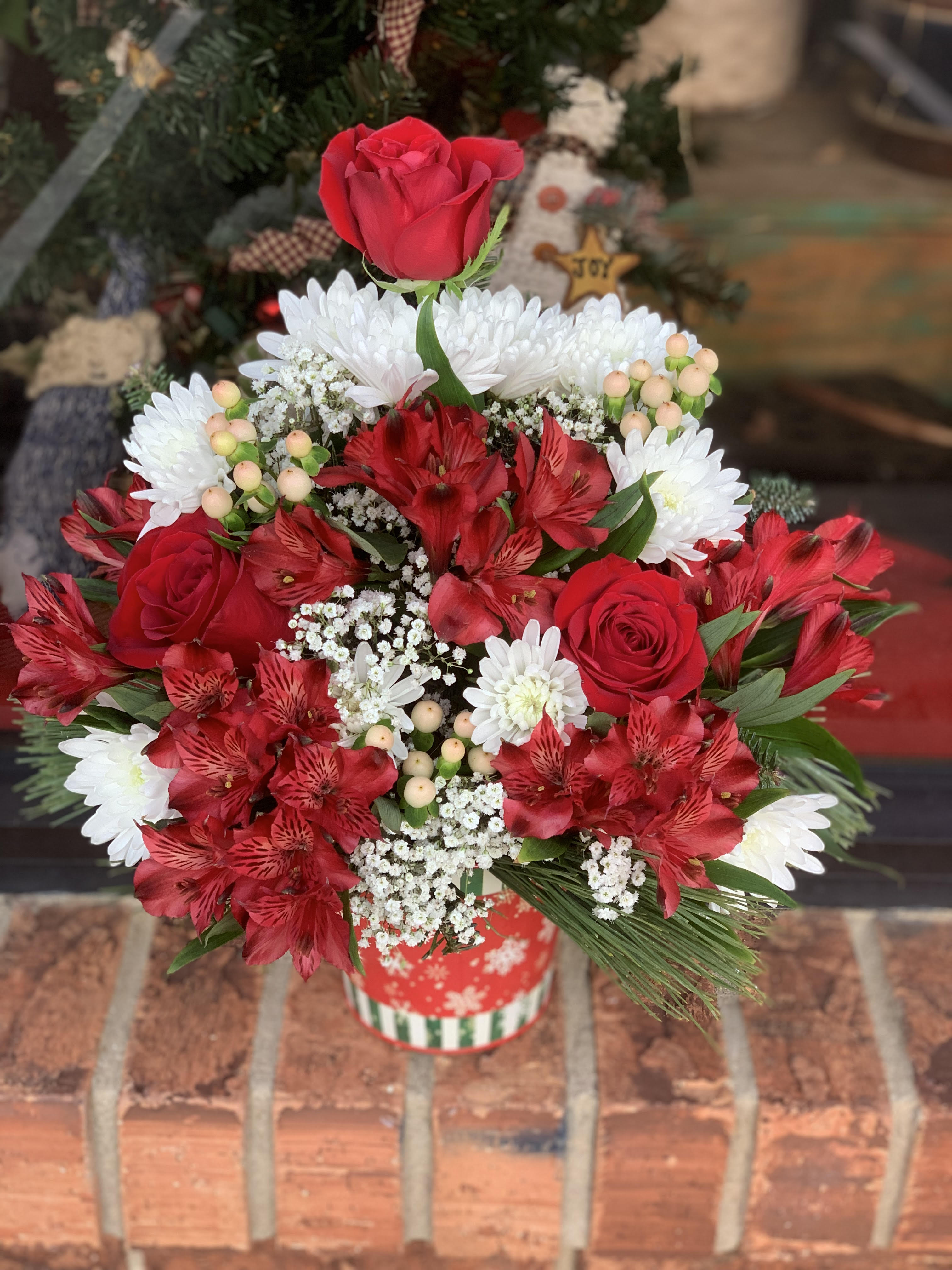 Merry Berries  - Make them merry with this sweet bouquet! Red roses,  red alstroemeria and hypericum berries  are beautifully presented in one of our many holiday tins. colors may vary on this front sided arrangement