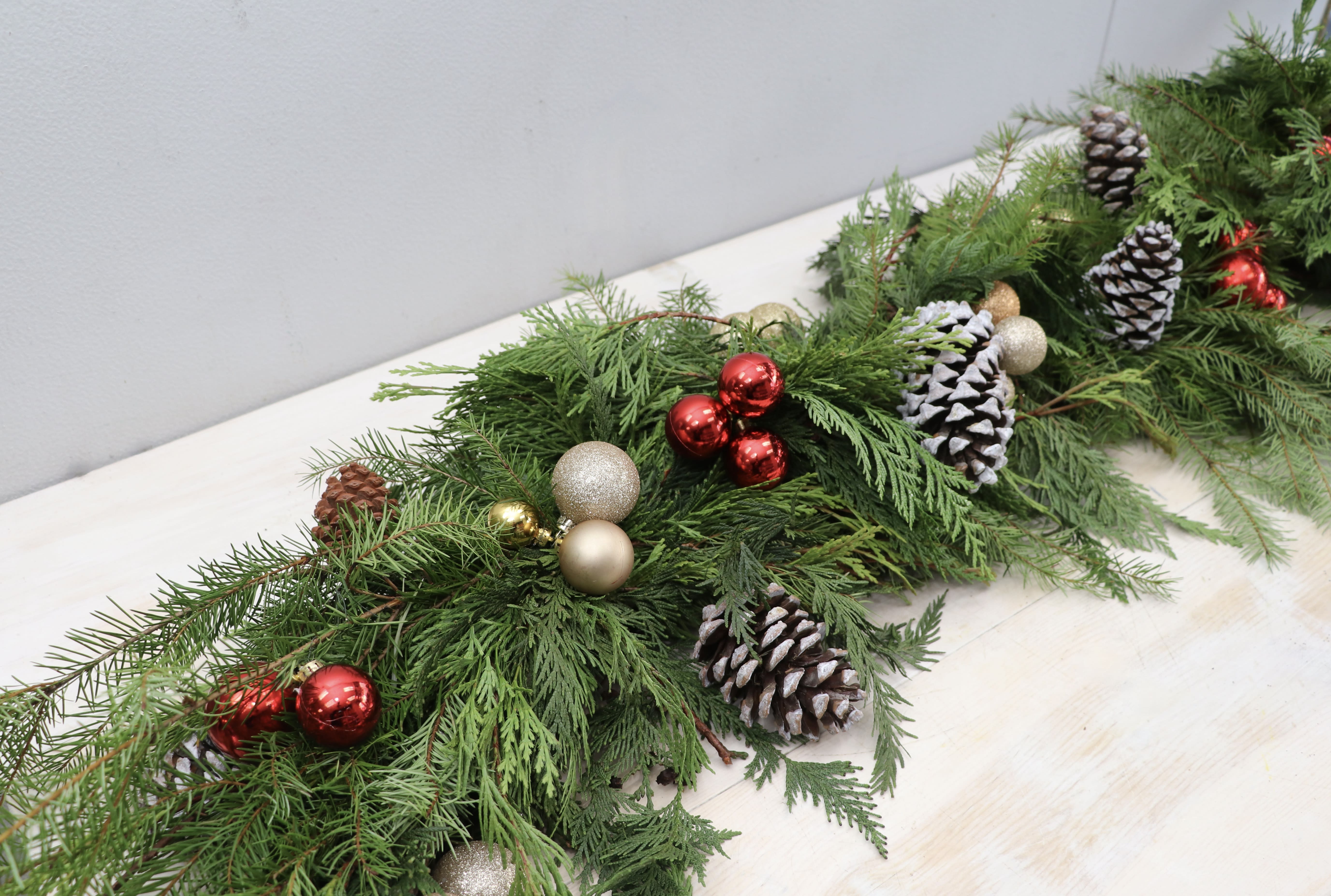 Holiday Garland - West Hollywood Flowers - Garland for all! Fresh greens decorated with pinecones and ornaments for your mantle, doorway, or anywhere needing some cheer. Standard - 3' of garland Deluxe - 6' of garland Premium - 9' of garland
