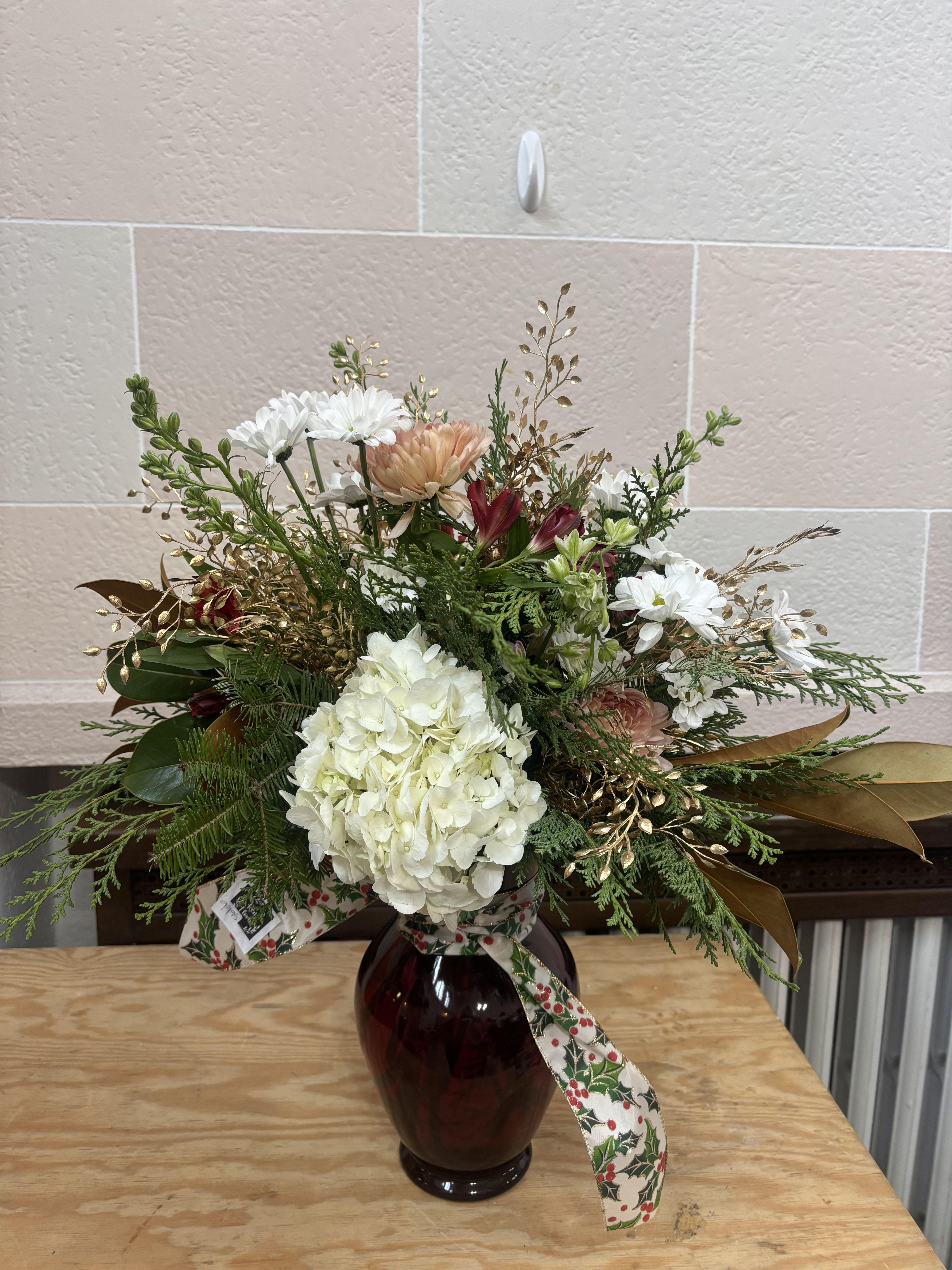 Winter Blooms Vase - A large red vase filled with our current stock of Christmas blooms. 