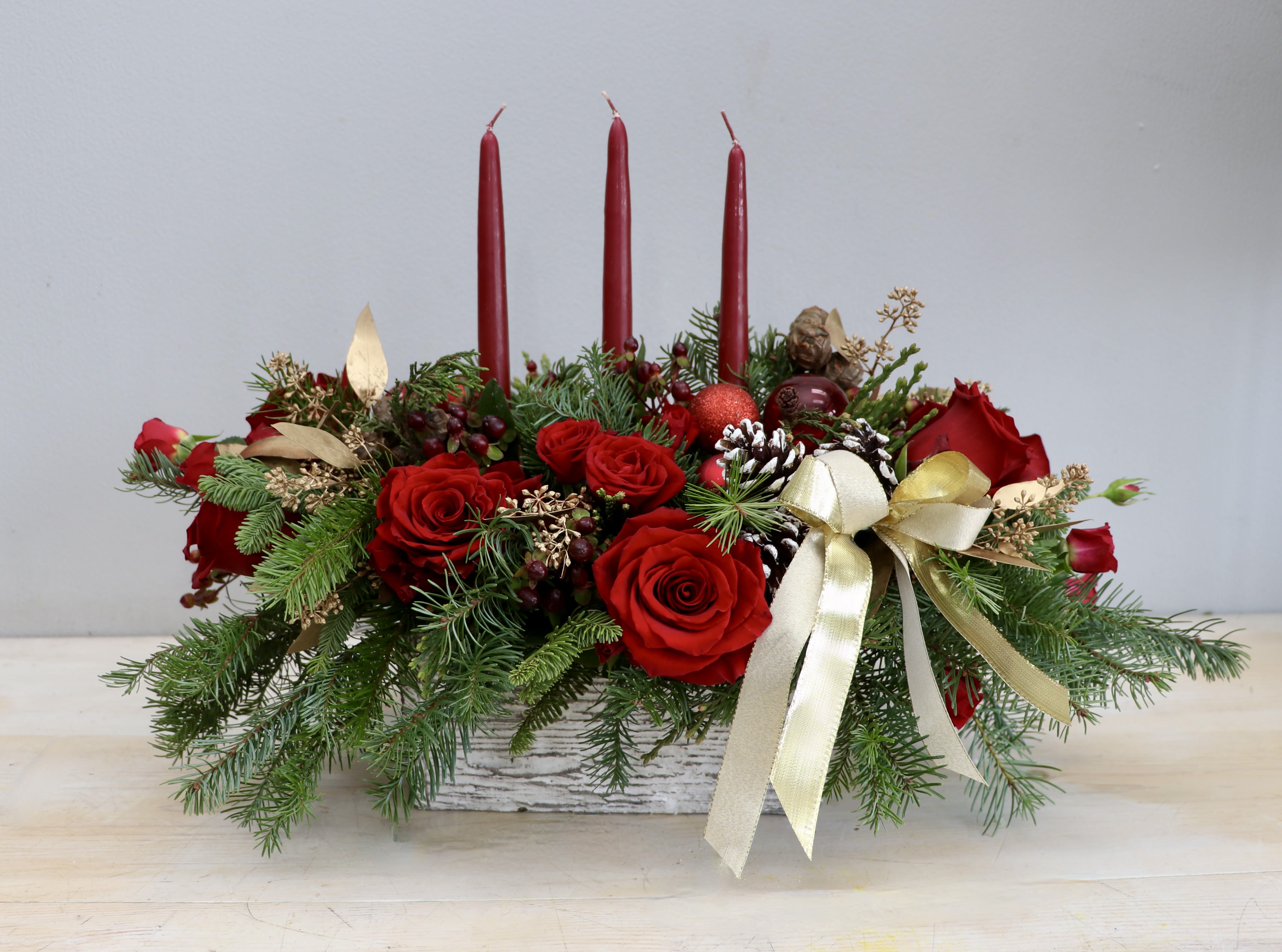Red Holiday Centerpiece - Glendale Florist - Change things up this year and place this gorgeous arrangement on your dining table! It will make sure to be a hit. 