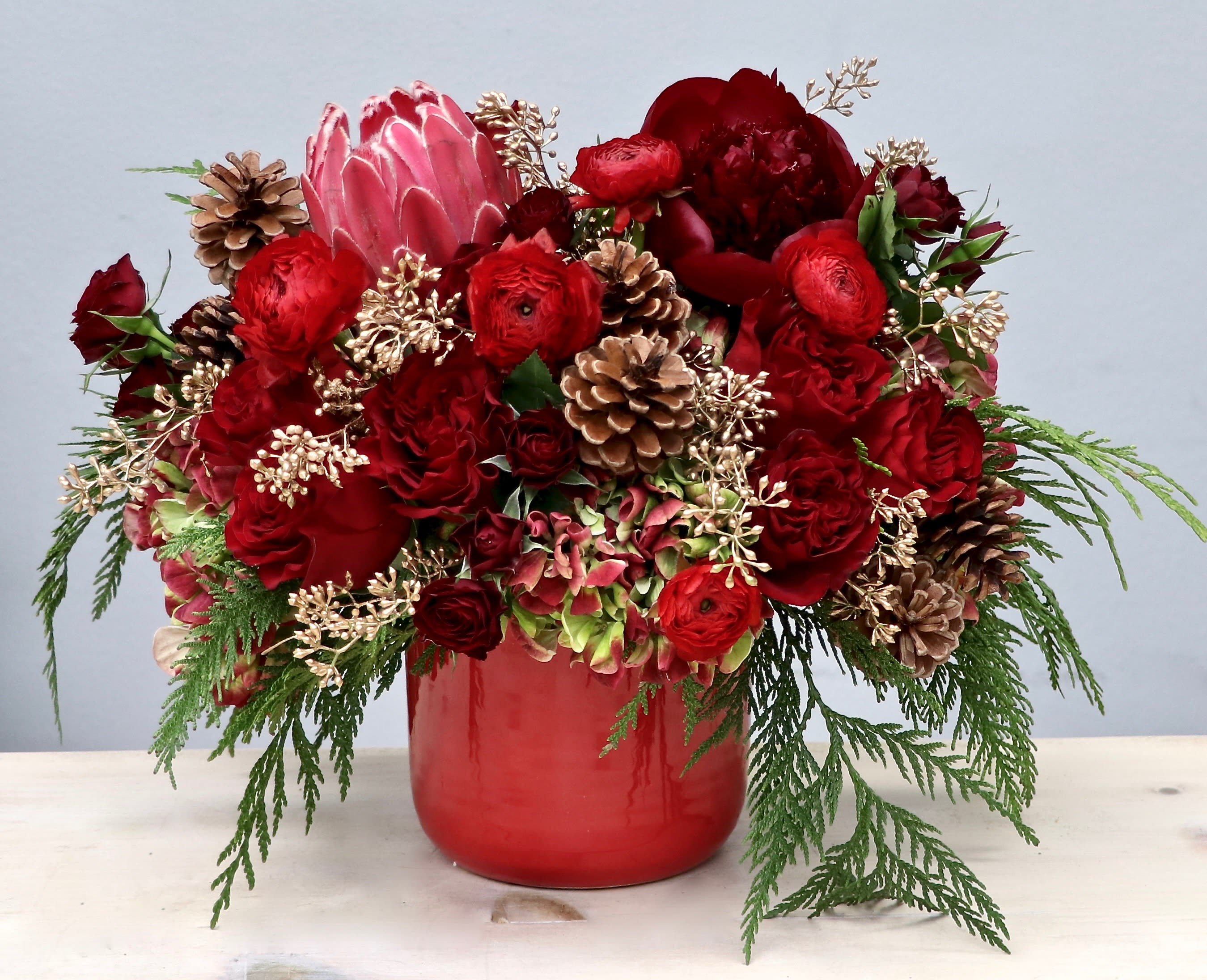 Red Rose Pine - My Glendale Florist  - This beautiful arrangement includes a mix of vibrant red roses, hydrangeas, and fragrant seasonal greens. 