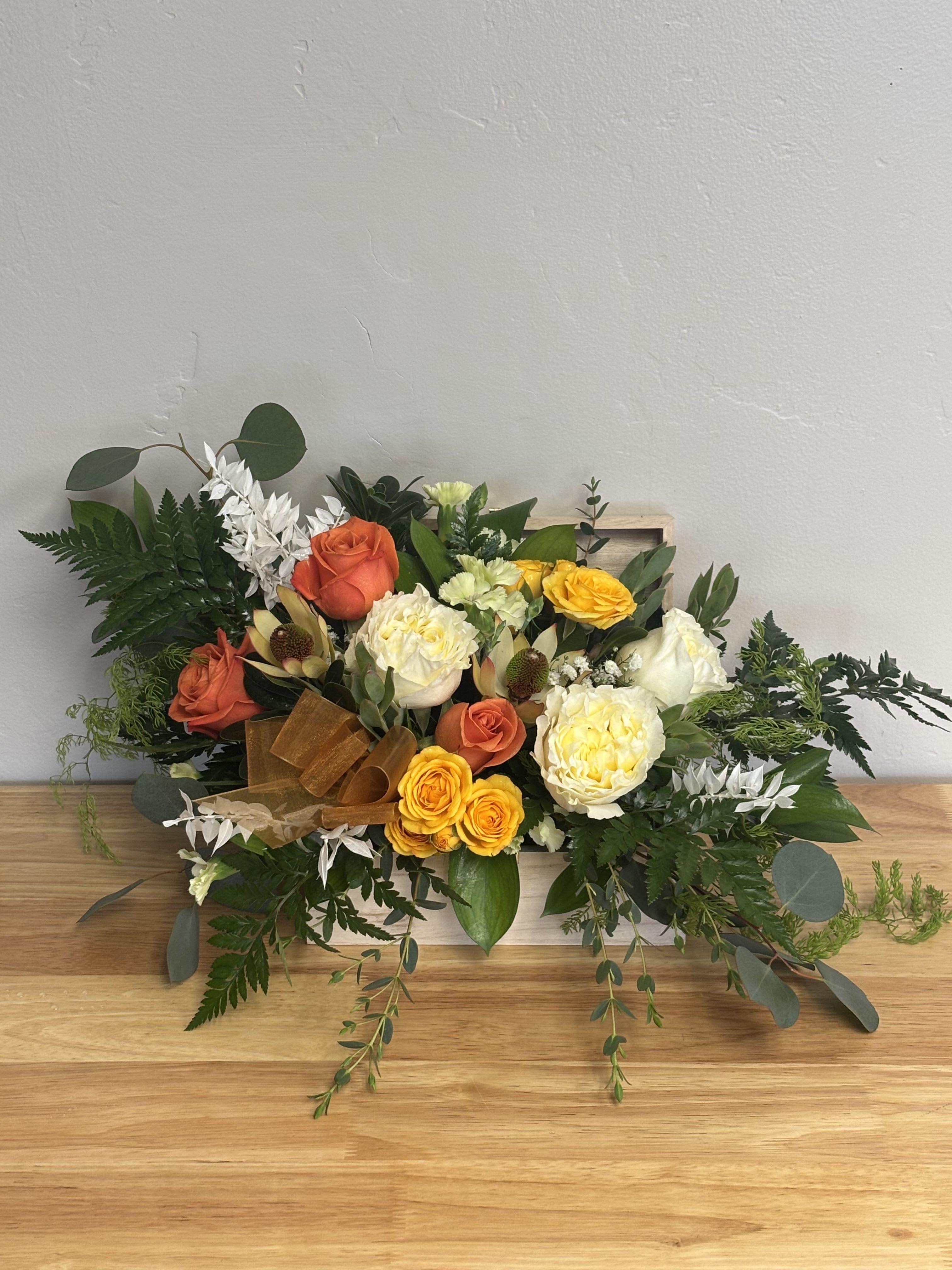 Golden Grace -  Golden Grace Arrangement  There’s something undeniably joyful about buttery yellow and creamy white roses—the perfect balance of warmth and elegance. Paired with in-season foliage like soft eucalyptus and finished with delicate preserved Italian ruscus, this design feels both fresh and timeless. The result is a floral that radiates happiness, sophistication, and effortless beauty—perfect for brightening any space or celebrating life’s golden moments. 