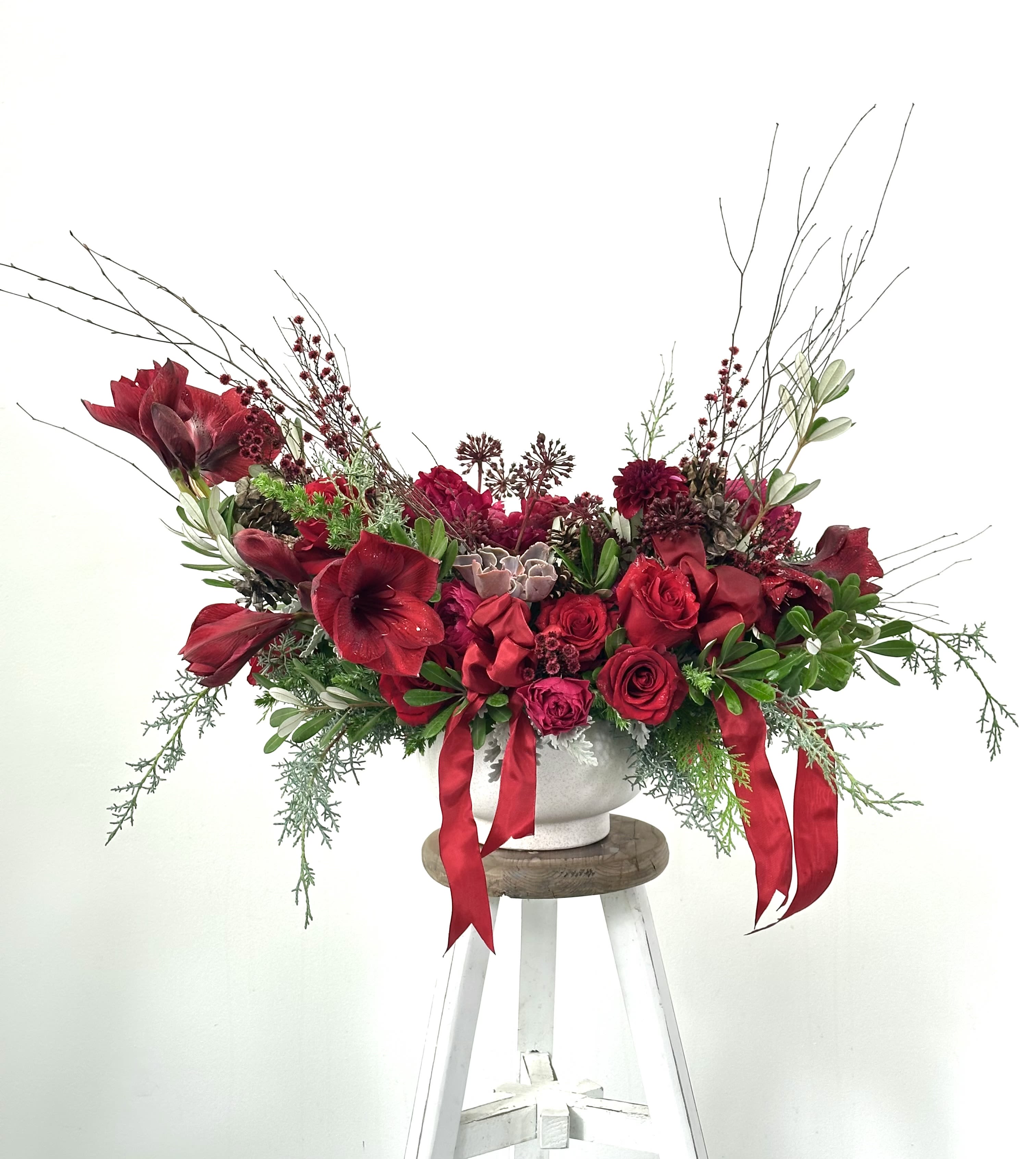 The Very Merry Chic Arrangement - Holiday at its chicest.  This Stunner is bursting with holiday flair.  The pinecones!  The bows!  The Florals!