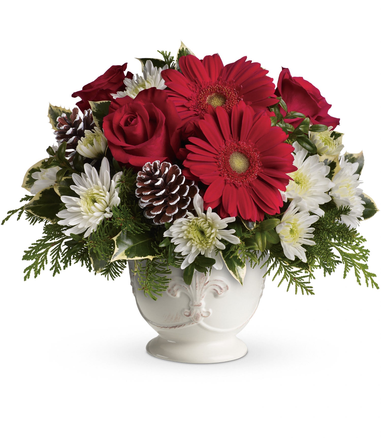 Teleflora's Simply Merry Centerpiece - Red gerberas, red roses and white cushion spray chrysanthemums are accented with tips of flat cedar, noble fir, holly and assorted greens. Delivered in Teleflora's French country pot.