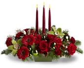 Dreaming of Christmas - Are you dreaming of a bright Christmas? Then make this stylish centerpiece the center of your holiday festivities. A medley of red and green blooms - including roses and orchids - is arranged with ornaments and evergreens around three tall taper candles. Truly sensational!  	