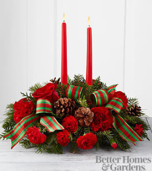 Holiday Classic Centerpiece - Holiday Classics Centerpiece. Drawing from the rich traditions of holiday décor, this festive centerpiece is set to lend its seasonal beauty to your holiday celebrations. Bright red roses, carnations and mini carnations are arranged amongst an assortment of holiday greens, accented with natural pinecones and a designer red and green striped ribbon. Encircling 2 red taper candles, this lovely centerpiece will bring warmth and Christmas charm to your holiday gatherings with each graceful bloom. 