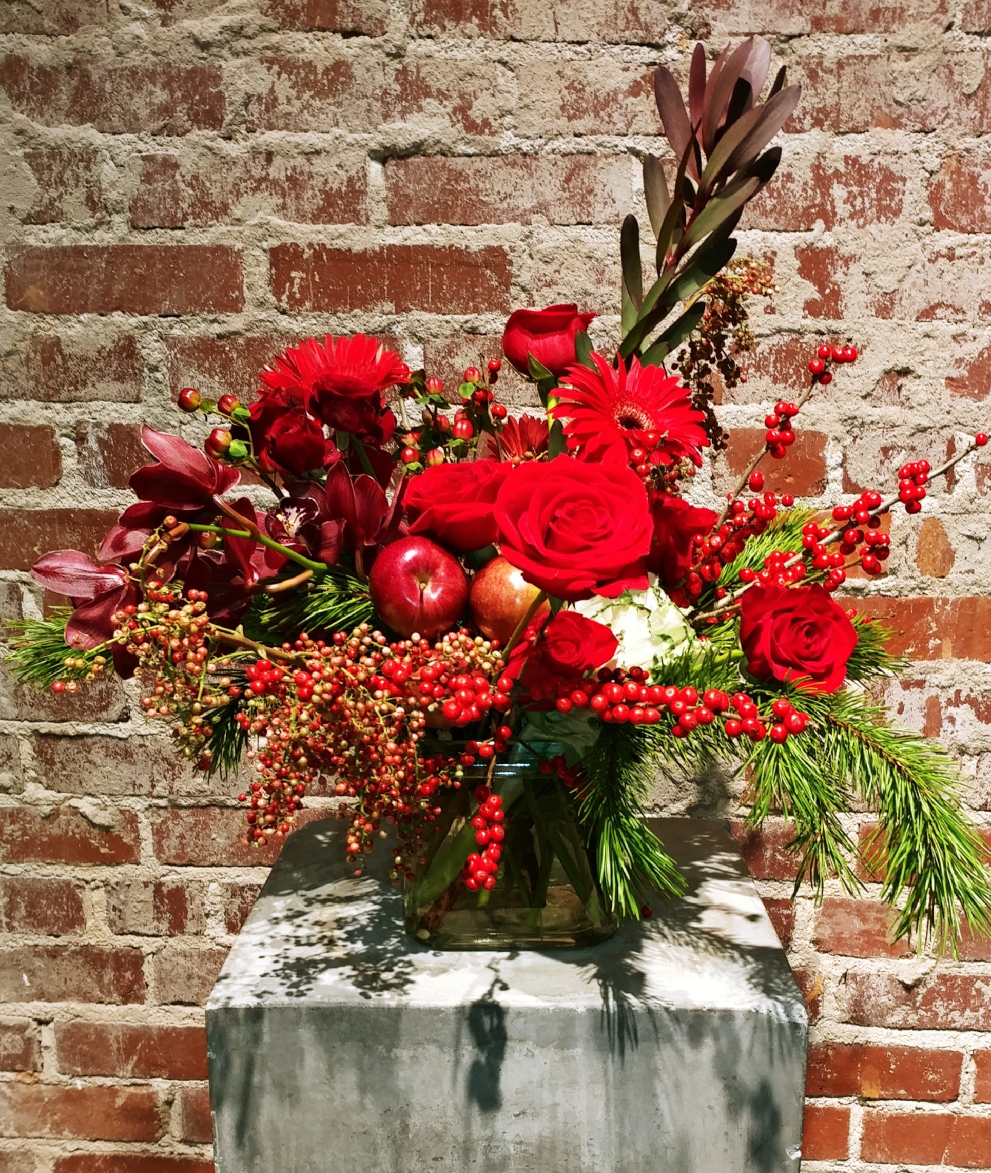 Winter Berry - Compilation of red seasonal blossoms paired with red winter berries and mixed evergreens. A perfect accent for your holiday table.