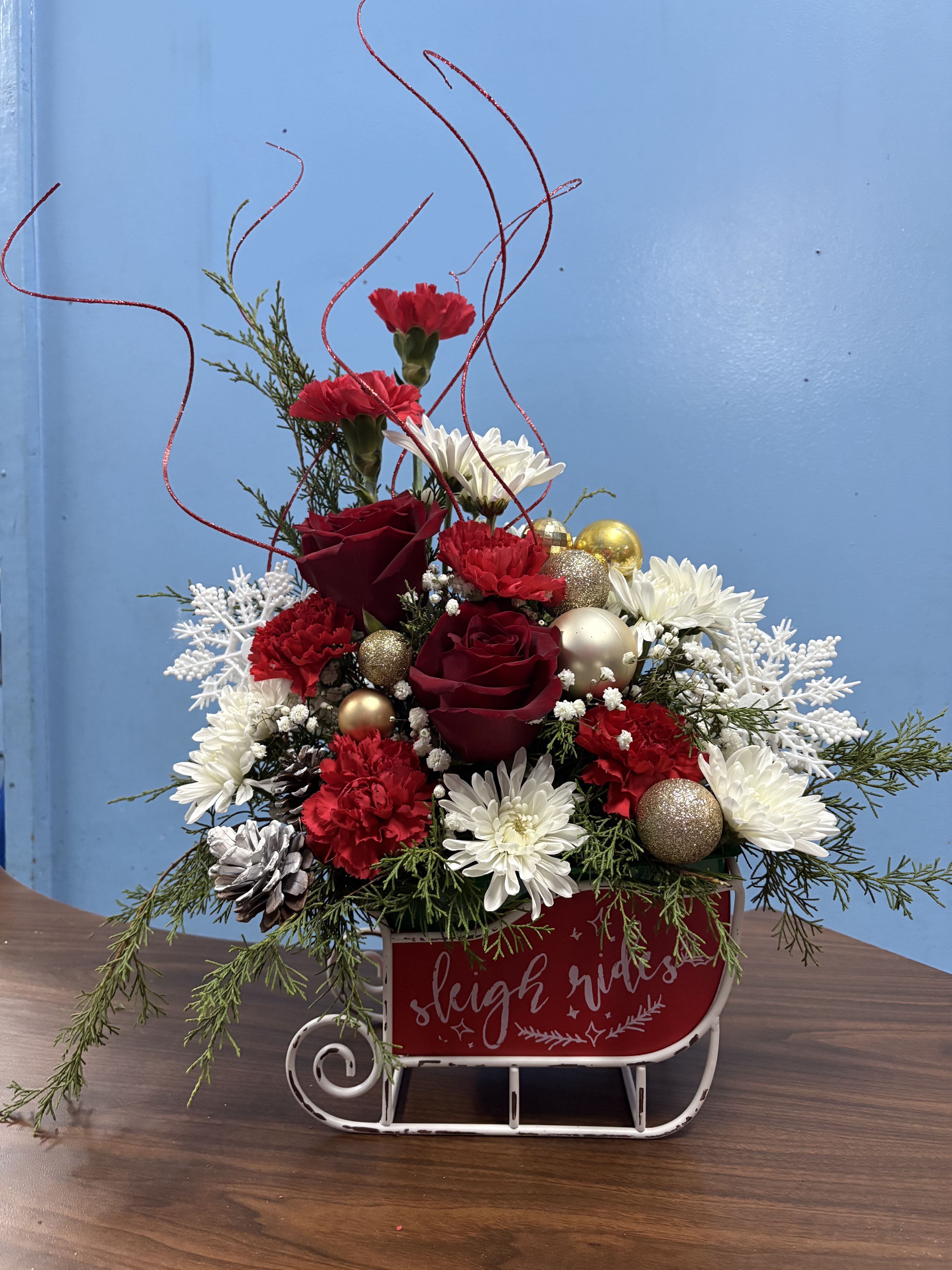 Sleigh Me Sled - Over the top Christmas arrangement designed in a unique keepsake sled that they can enjoy year after year. What a great way to send the Christmas cheer to your friends and family 