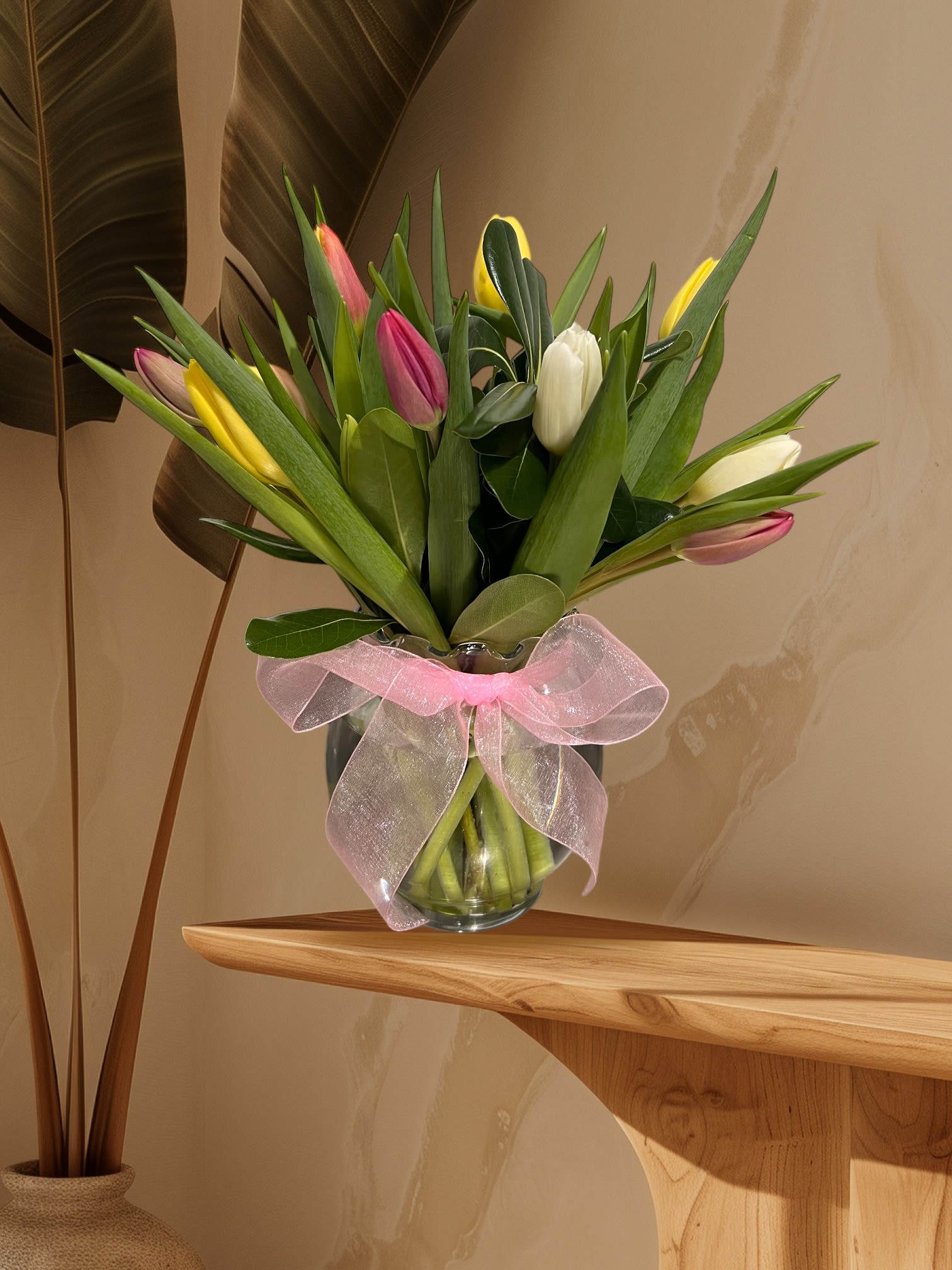 Tulip Delight  - A clear vase filled with assorted tulips and greenery. Simple and beautiful