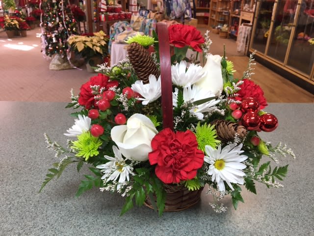 Christmas Joy Basket (CJ) - Send Christmas cheer with this lovely basket filled with assorted Christmas greens, berries, roses and more.  ***Please note basket may differ from pictured****  