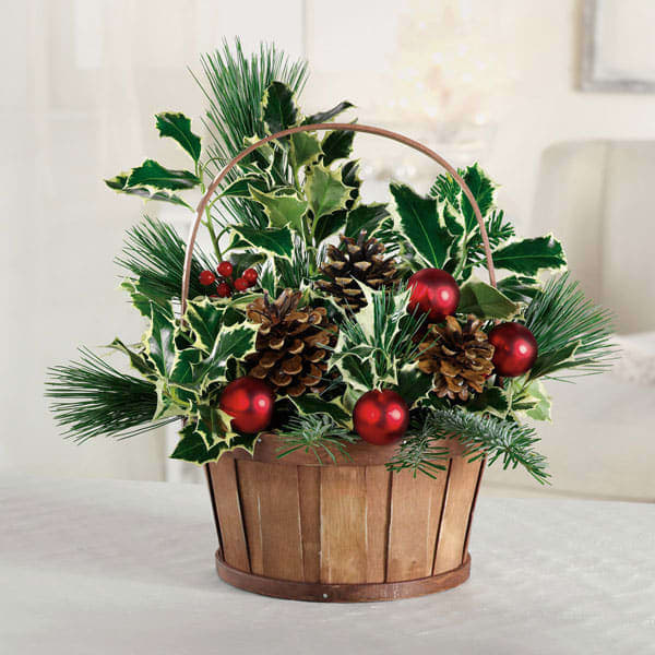 Holly And Pine Cone Basket - Filled with the classic colors of Christmas, our exclusive bouquet is a wonderful gift to thank the party hostess or to use as a Christmas Arrangement Centerpiece your own holiday home.