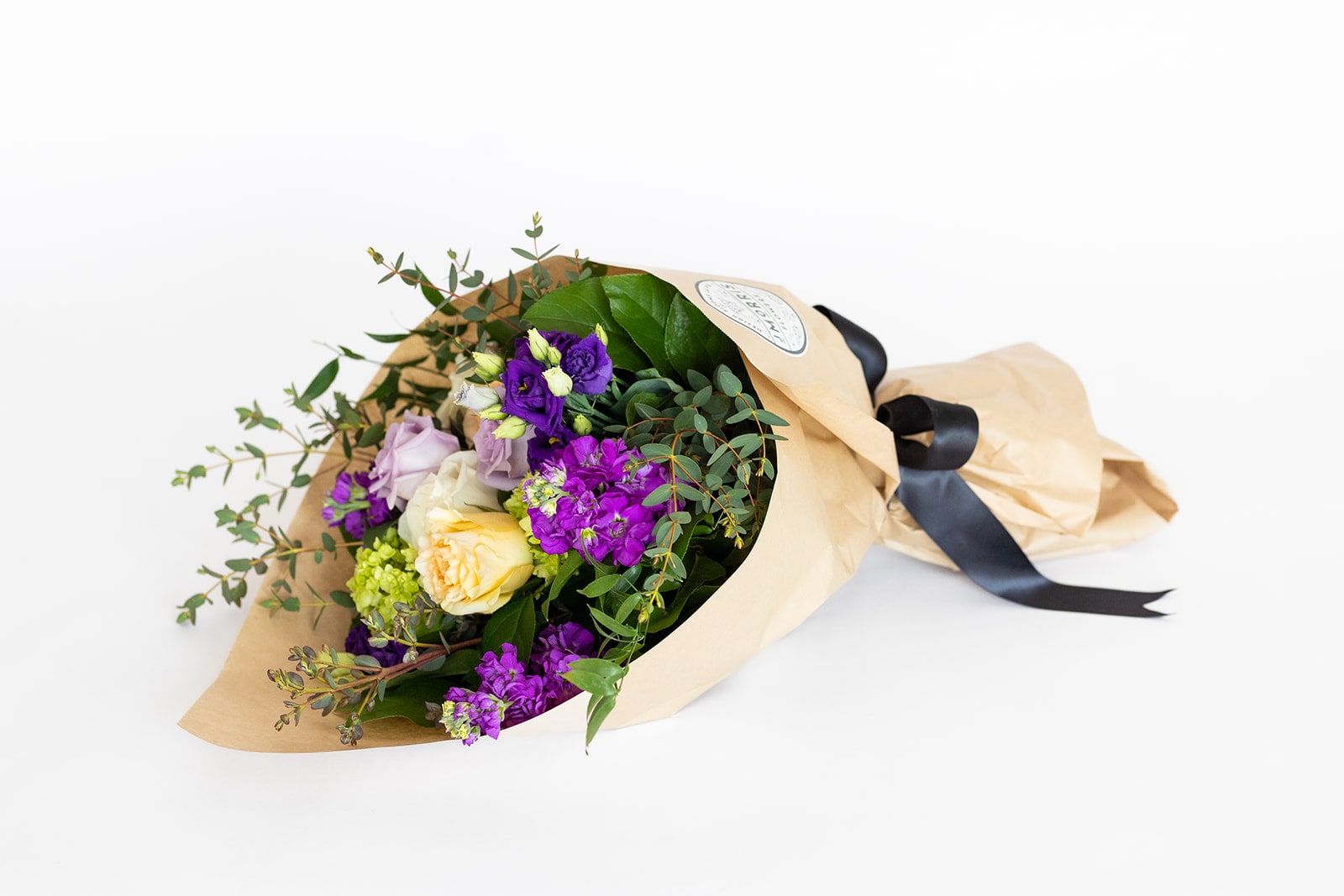 A Day in Paris - Wrapped Bouquet  - Vibrant and inspiring blooms that remind us of a day in the city of love - Paris. Garden roses, roses, Hydrangea, and Lisianthus in spring shades of green, peach, lavender and purple. Who wouldn’t want to receive A Day in Paris from someone they love.    A hand-tied bouquet of fresh cut blooms and greenery designed and ready for a favorite vase. Perfect for a thank you gift, get well wish, Anniversary, birthday or hostess/host gift.   Dimensions: Wrapped bouquets are 18&quot; long and 12&quot; wide, wrapped in paper and tied with ribbon. The bouquet has a water source inside to keep it fresh for delivery.  