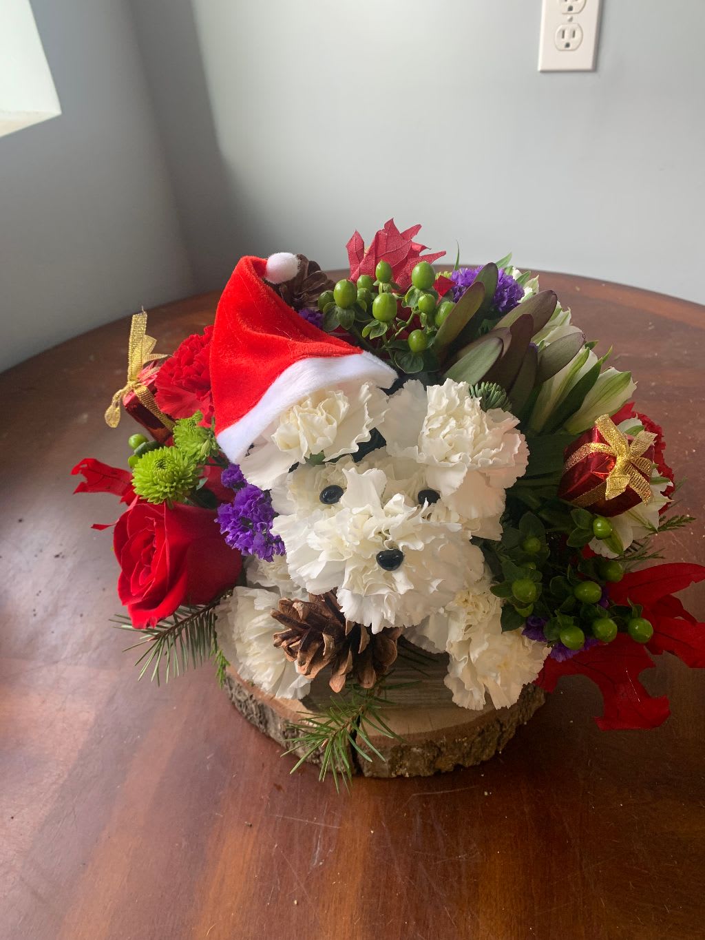 puppy claus - puppy out of carnations... with a round mixed floral arrangement with seasonal flowers