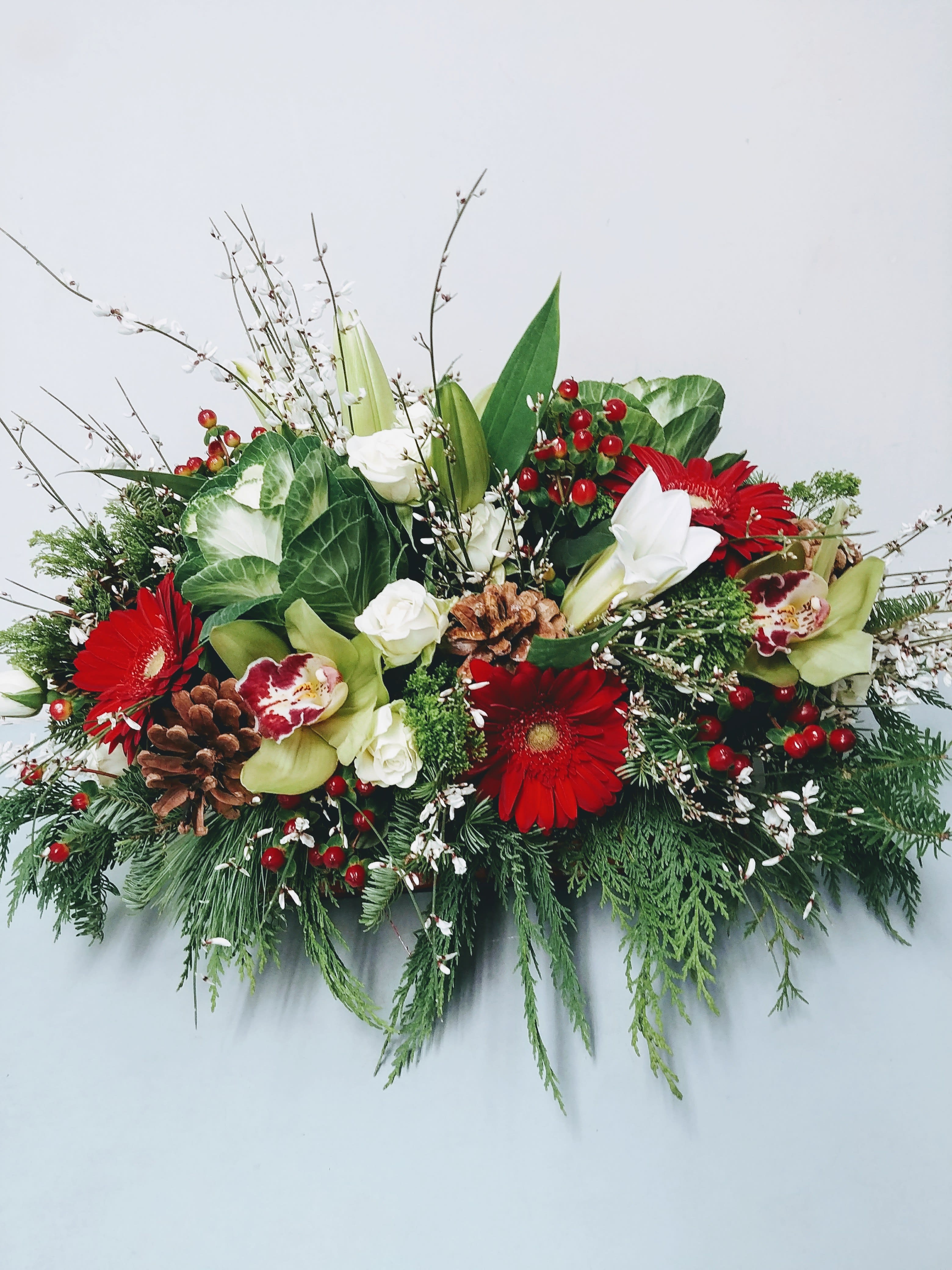 xmas centerpiece - kale, cymbidium orchids, gerbera daisies, roses, genestra