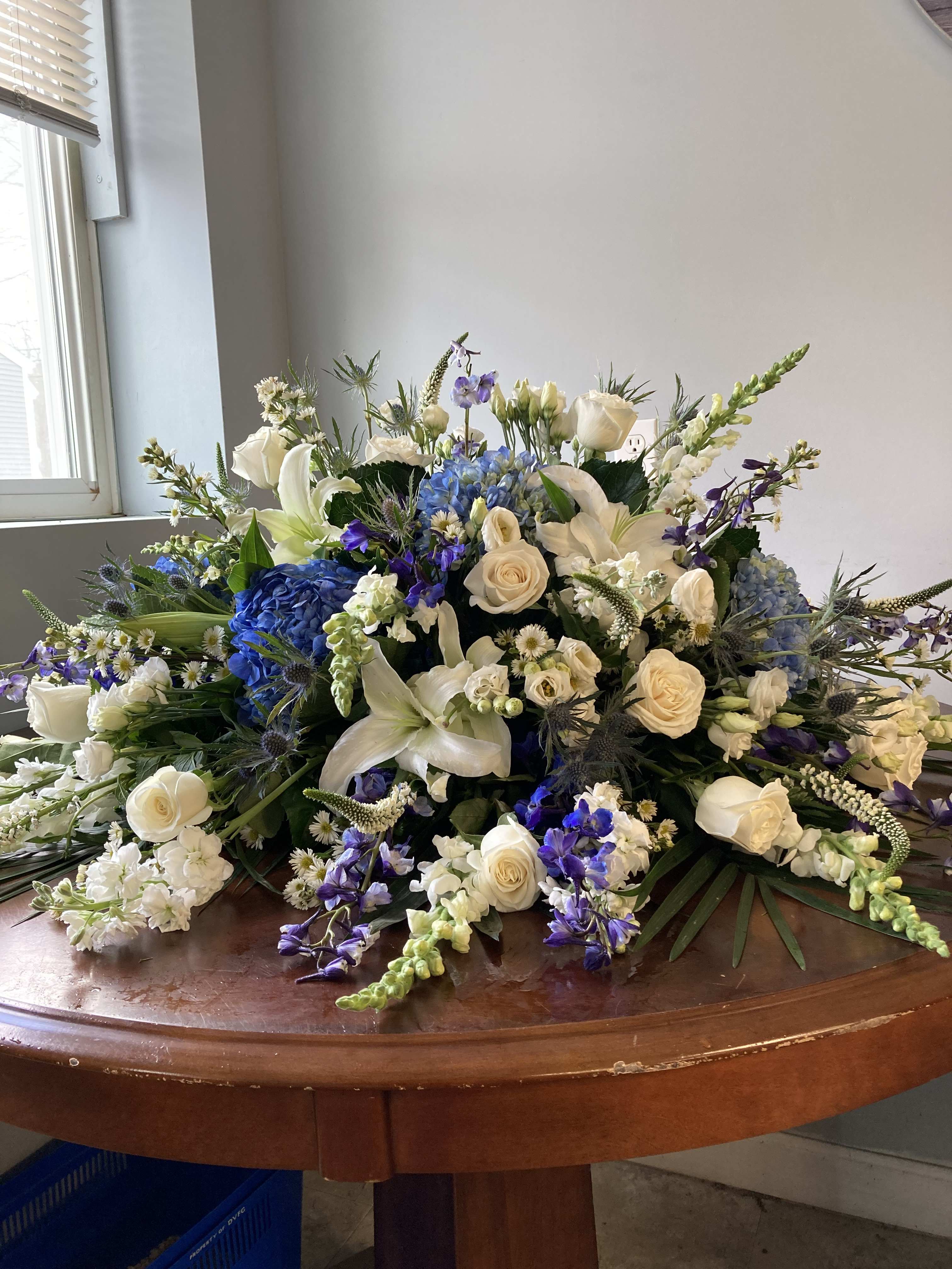 blue and white casket cover - all blue and white flowers for this lovely casket cover: flowers like: hydrangeas, roses, delphinium, fugis, and many more. 