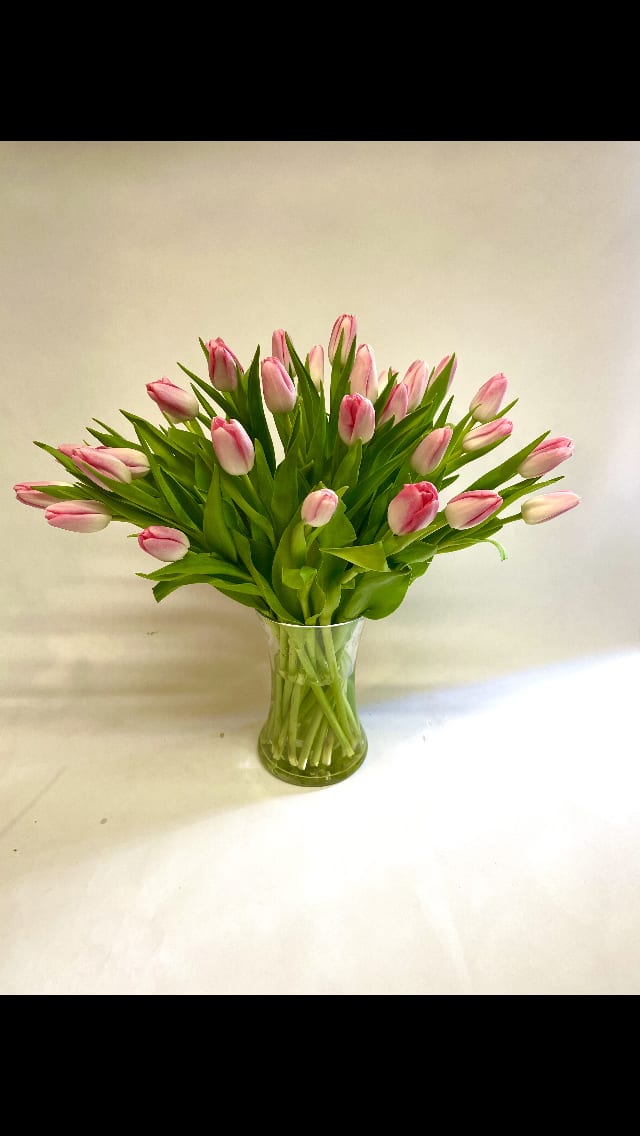 Fresh and Lush Tulips Bouquet - This sweet and simple arrangement features 30 stems of tulips in a  vase.  Colors based on availability, please call to inquire   Featured Jar :$95.75.