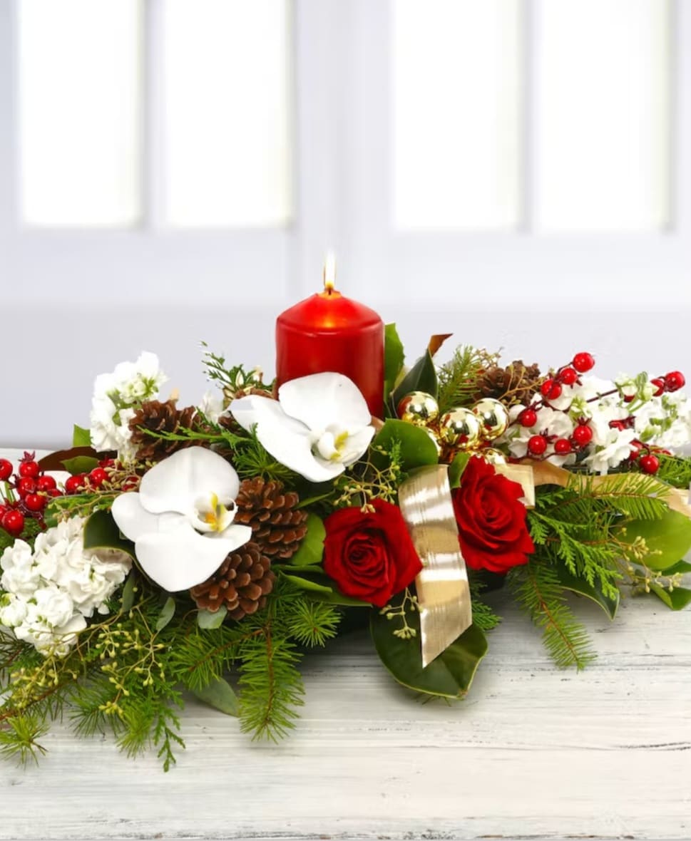 Happy Holidays Centerpiece  - This impressive decorative centerpiece with red  pillar candle will not only make the holidays merrier it'll make them jollier too. White stocks or and white snaps orchids and red roses with berry's  Picture is premium sizew