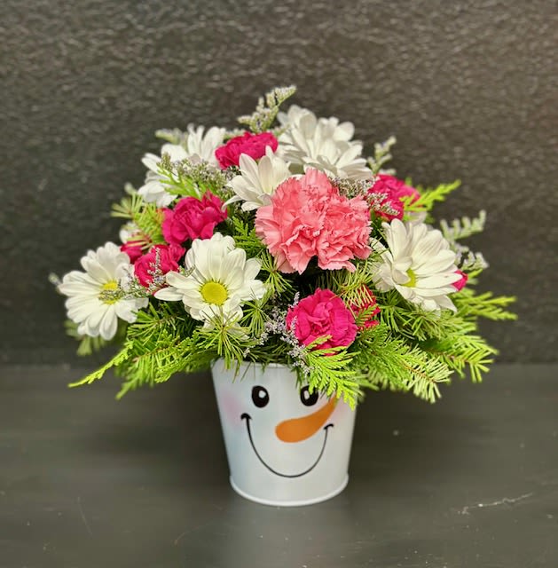Frosty the Snowman - This adorable snowman tin will bring cheer for the entire holiday season!  Filled with long lasting flowers like carnations, daisies and mums along with fragrant Christmas greens.