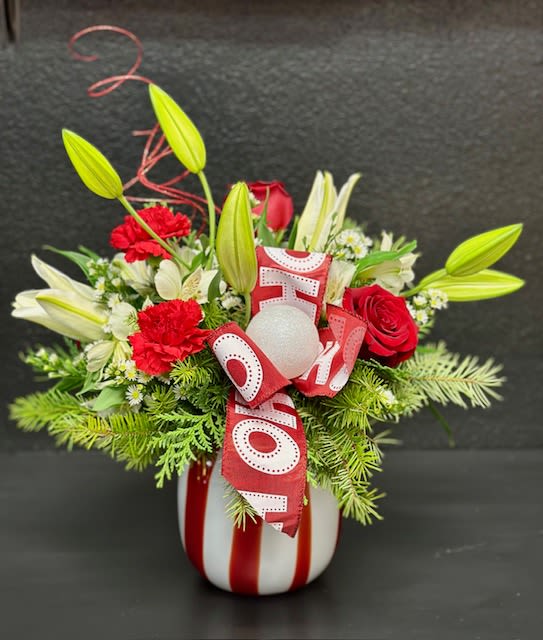 Peppermint Wishes - This beautiful swirl vase is sure to put a smile on the face of anyone who receives it!  This gorgeous, keepsake glass vase is filled with holiday cheer including red roses, carnation and white lilies.   