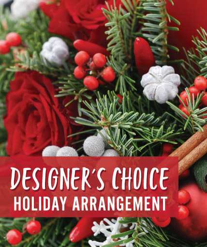 Designers Choice Christmas - Put the holiday spirit in the hands of our talented designers and let them deliver Christmas magic.  Using the freshest seasonal flowers arranged in a vase with evergreens and a seasonal bow.