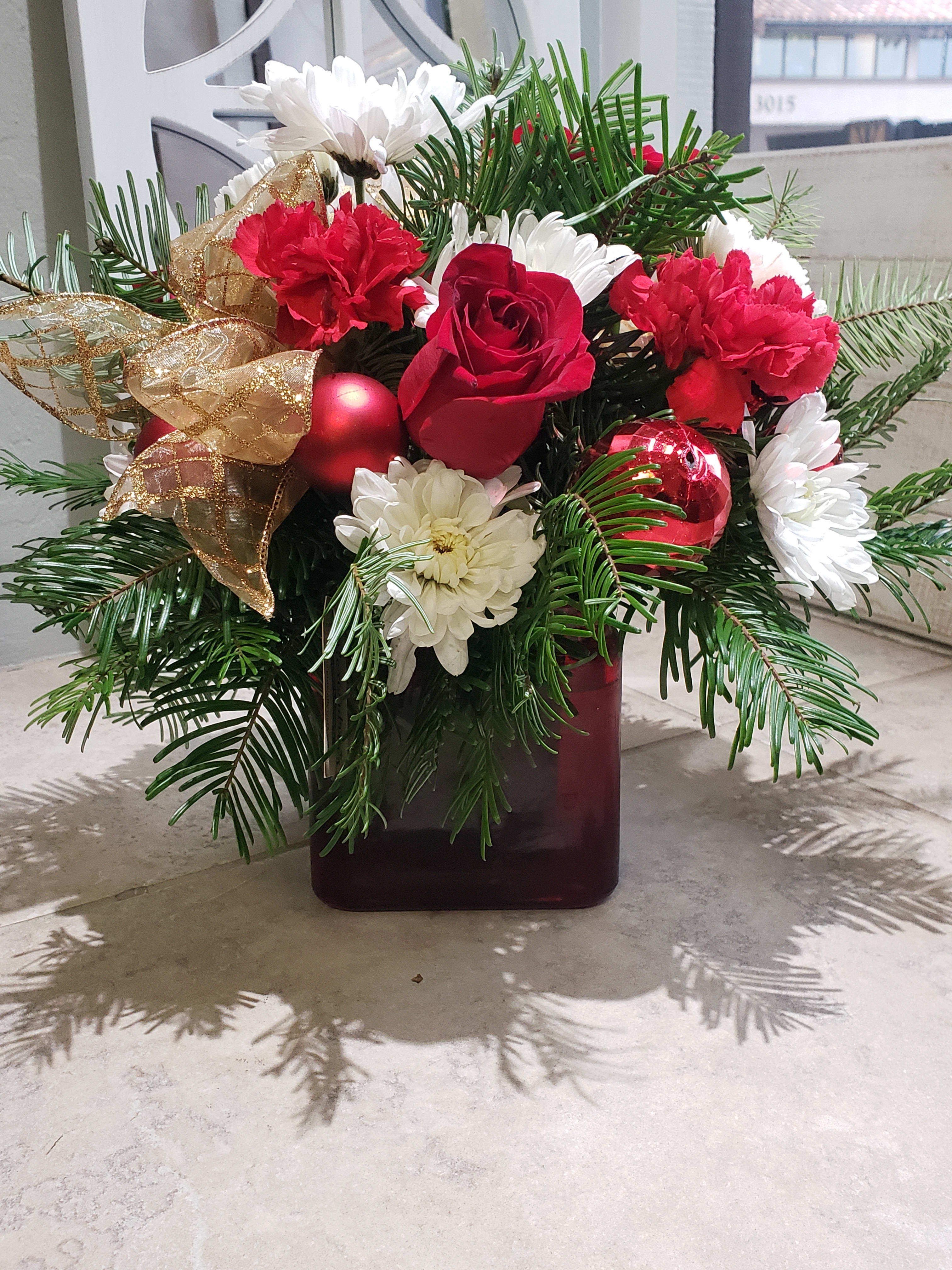 Holiday Cube Mix 4x4  - A sweet  Holiday mix of seasonal blooms and winter greens.  This design is low and  small perfect for a small coffee table. 