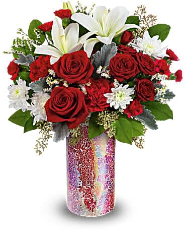 Teleflora's Love Sparkles Bouquet - Make Valentine's Day sparkle with this vibrant mosaic glass keepsake vase, bursting with romantic roses and lilies. Red roses, red spray roses, white asiatic lilies, red carnations, miniature red carnations, white cushion spray chrysanthemums and white limonium are arranged with dusty miller, seeded eucalyptus and lemon leaf. Delivered in a Love Sparkles vase.