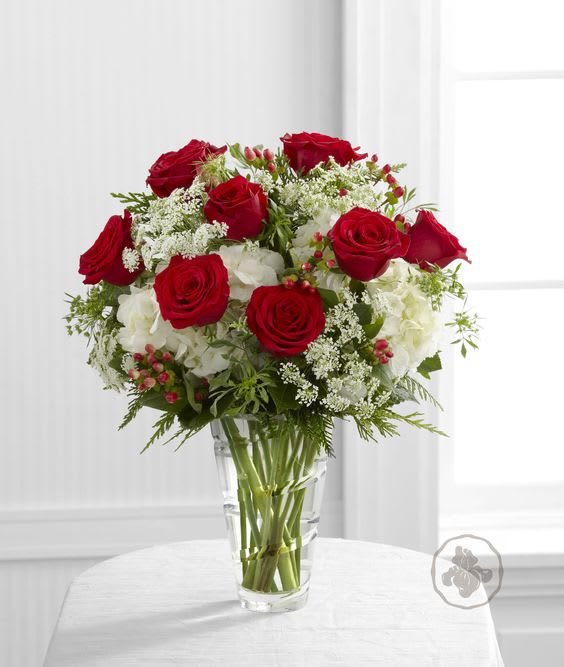 Holiday Celebrations - Celebrate the season and your love for her with this beautiful arrangement of roses, hydrangea and Christmas greens.
