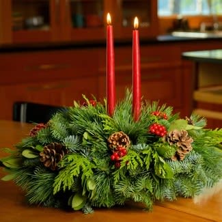 PNW Christmas Centerpiece - This traditional centerpiece arrangement combines a delightful blend of fresh noble fir, cedar, and pine with two red candle tapers.