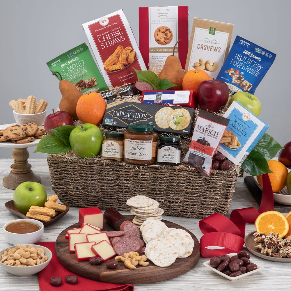 Gourmet Fruit Basket - This exquisite gift is guaranteed to impress! Inside a gorgeous seagrass basket, we’ve artfully arranged an assortment of freshly harvested fruits, including crisp hand-picked apples, juicy oranges, and tender pears, along with a variety of gourmet foods. Boasting irresistible snacks like classic Vermont cheddar, artisan crackers, garlic sausage, a salted caramel dip, and so much more. This lovely gift basket is perfect for almost every occasion.