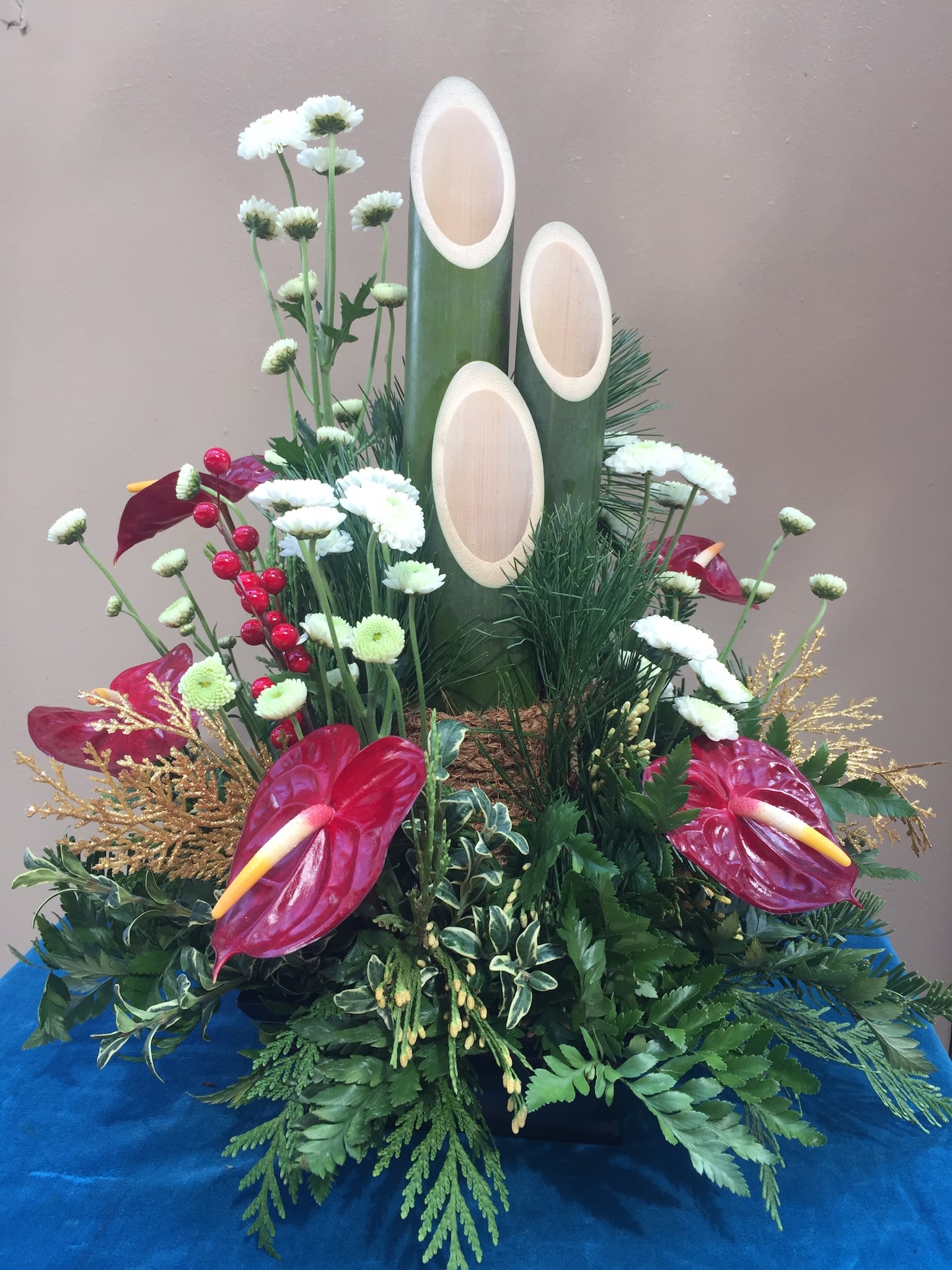 Elegant tropicals Kadomatsu KADO-008 - Bold red  antherium and delicate white chrysanthemums plus holiday sparkles surrounds the stately Kadomatsu is both cheerful and inviting 