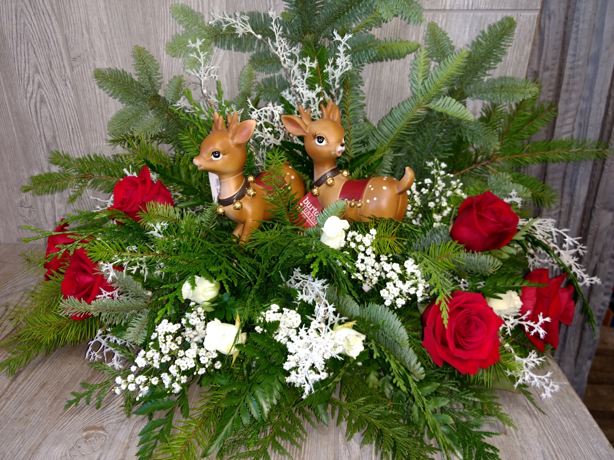 Reindeer games - A pair of vintage inspired reindeer play among holiday greenery and flowers.  High end Christmas table arrangement 