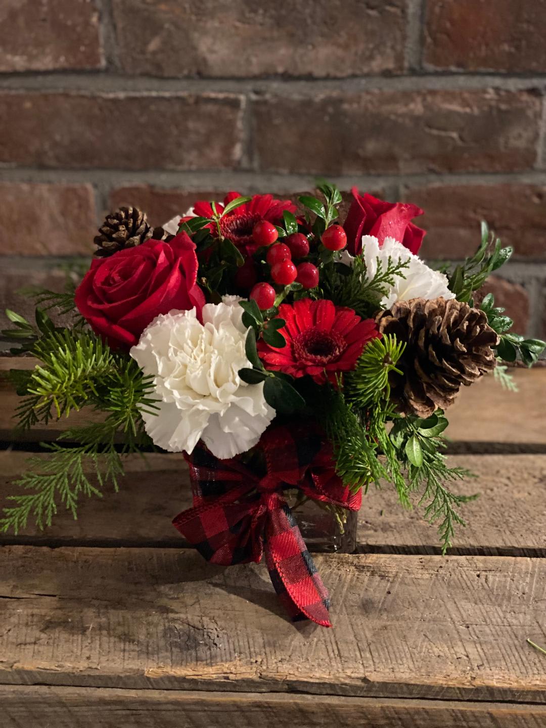 Christmas petite &amp; pretty - Petite cube filled with Christmas greens,berries, pinecones &amp; mix of white &amp; red flowers.