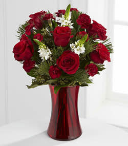 Holiday Romance -  Rich red roses, lush holiday greens and a touch of white- what better way to show that special someone a bit of holiday cheer while you say I love you! Flower delivery Kissimmee. Flower delivery Disney resorts