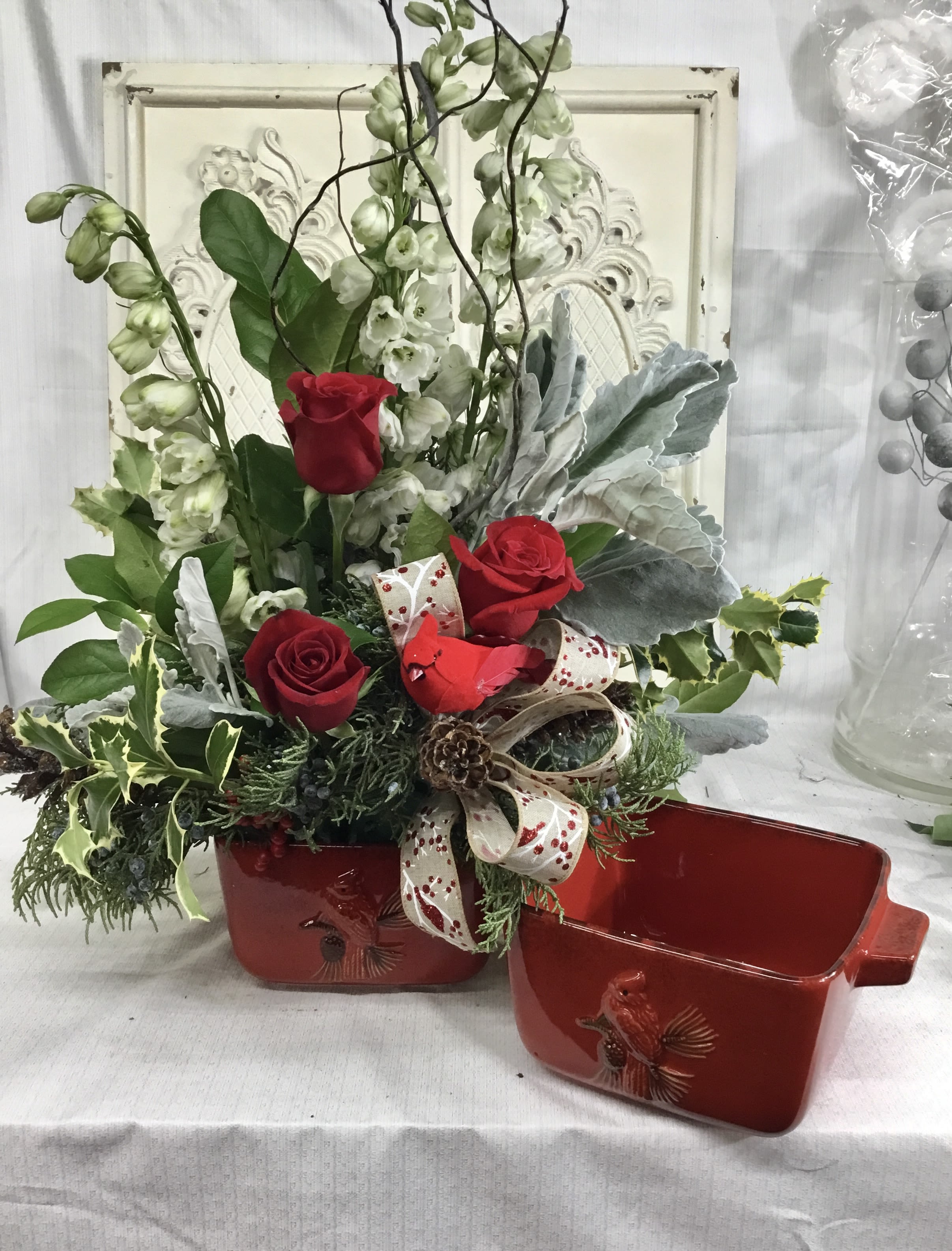 Ceramic Cardinal Baking Dish Arrangment - A Square Red Stoneware Baking Dish, with a Cardinal and Pine Branch embellishment, with beautiful holiday flowers.
