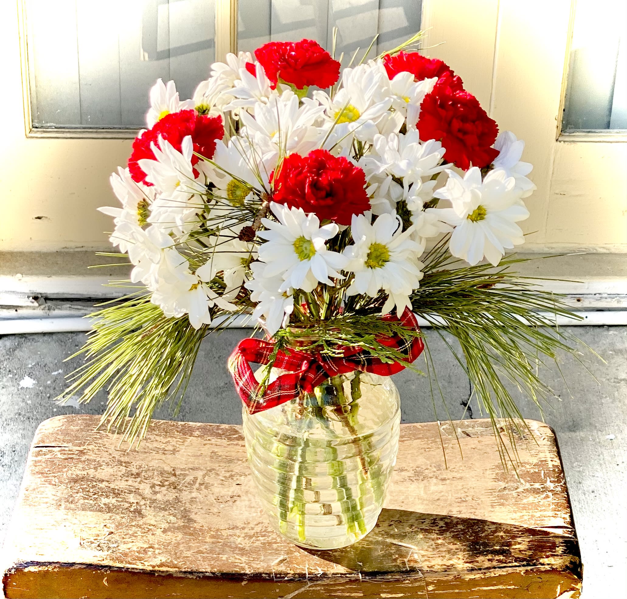 Carnation &amp; Daisy Joy Bouquet - This joyful red carnation and white daisy accented with winter greens bouquet is sure to light up their home with joy.