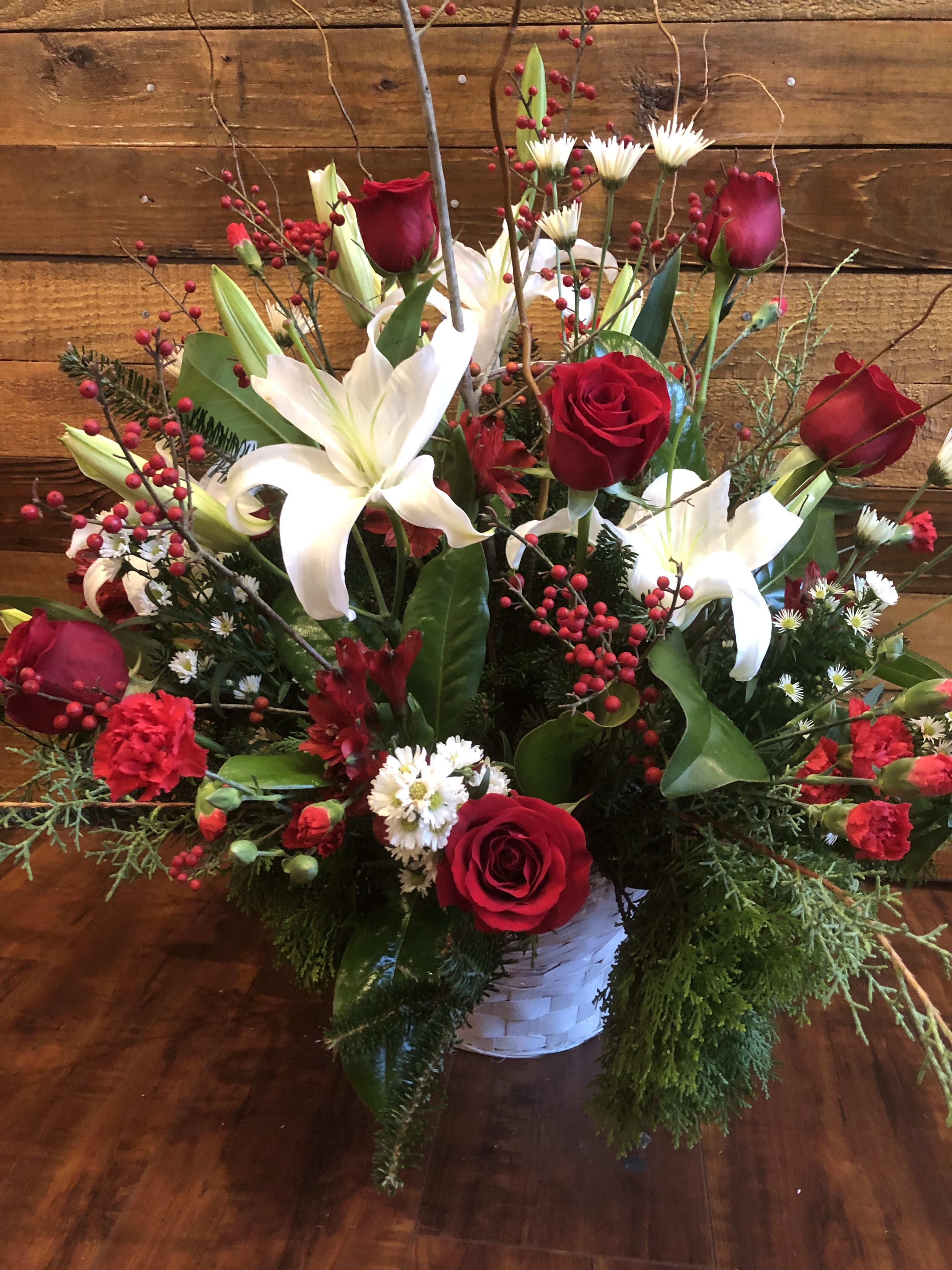 Christmas Blessings - Arrangement in a Basket Filled with Seasonal Evergreens and Fresh Flowers