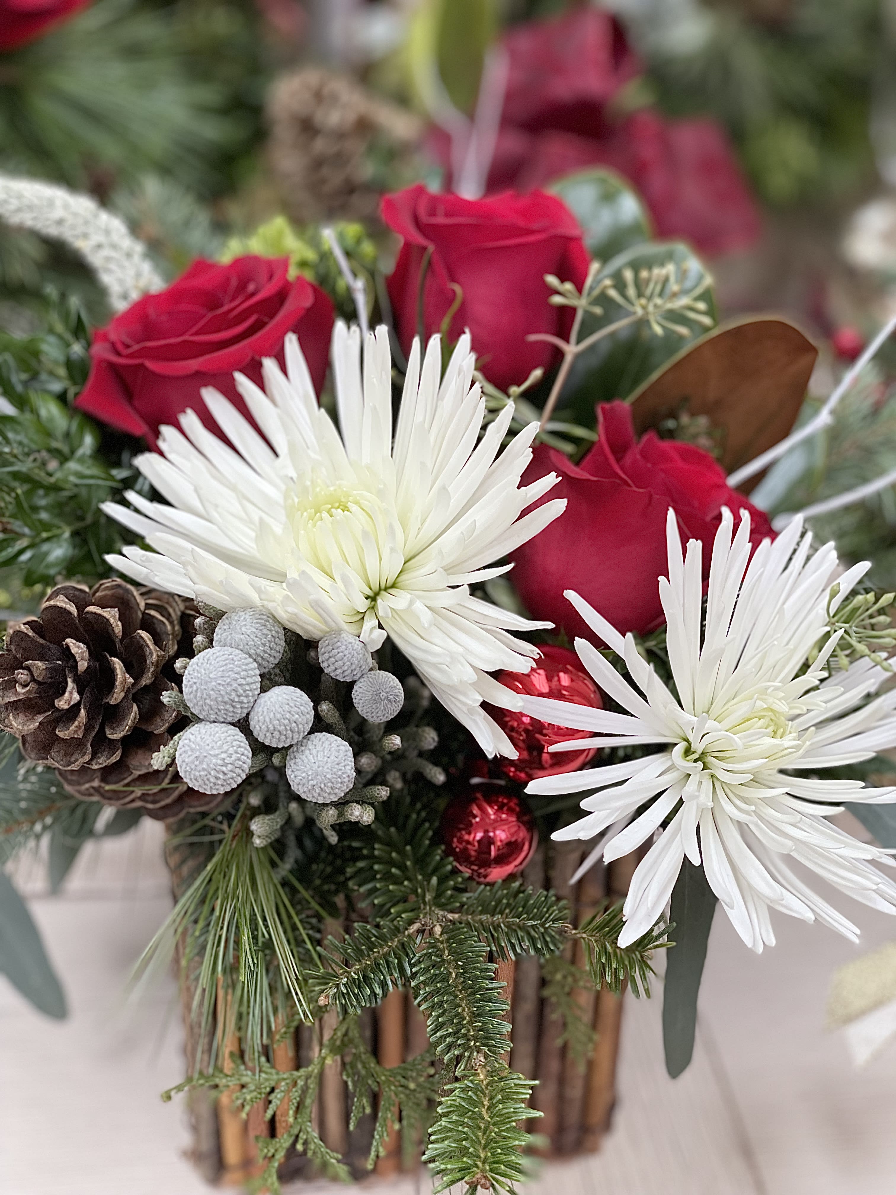 Christmas Red and White - A Christmas arrangement with traditional flowers and greens, we have added some textural elements and a little bling.