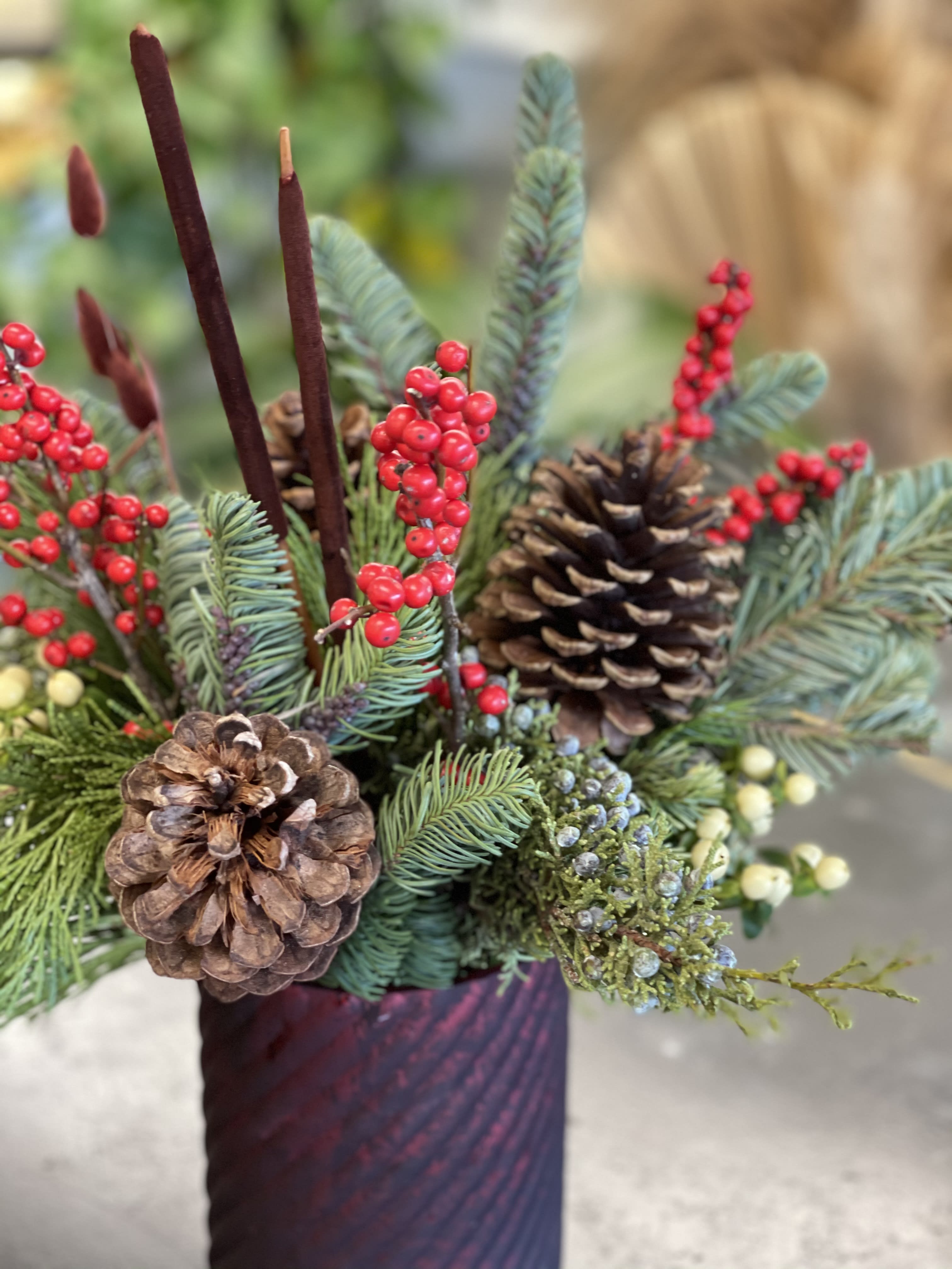 Winter Textures - This fragrant arrangement is made up of a variety of evergreens for that Christmas tree scent, along with pinecones, berries, cinnamon etc. for long-lasting seasonal accents. 