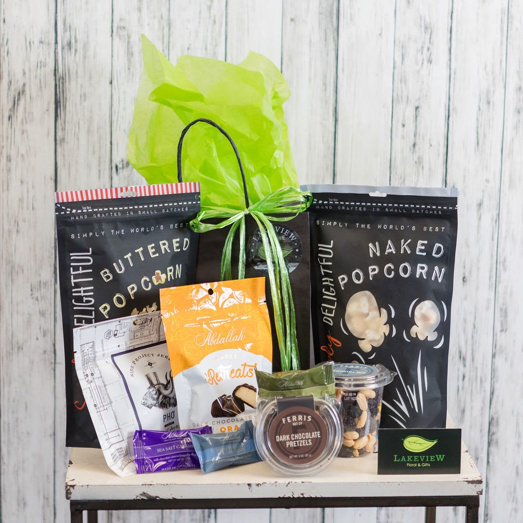 Snack - A sweet and salty snack gift will be sure to put a smile on someone's face! Includes popcorn, caramels, trail mix, assorted nuts, and chocolates. Perfect to share, or not!