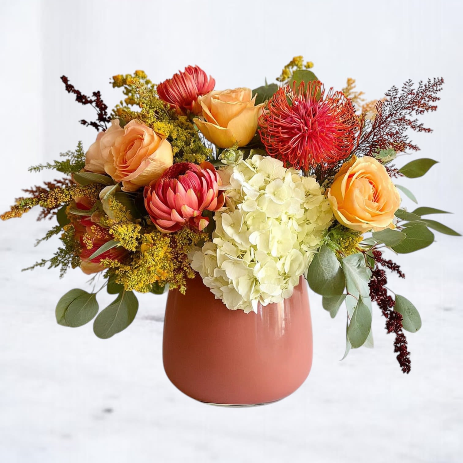 Citrus Prairie - Bright, uplifting, and full of modern texture, the Citrus Prairie Arrangement features a sculptural blend of peach roses, coral pincushion protea, ivory hydrangea, and fresh greenery arranged in a matte terracotta vase. Its vibrant palette and layered design bring warmth and cheer to any space — effortlessly stylish without feeling seasonal.  Handcrafted by Whiskey Wallflower, this arrangement is a stunning choice for birthdays, celebrations, thoughtful thank-yous, housewarmings, or simply brightening someone’s day.  Available for same-day flower delivery in Magnolia, The Woodlands, Conroe, Tomball, and surrounding Houston areas.