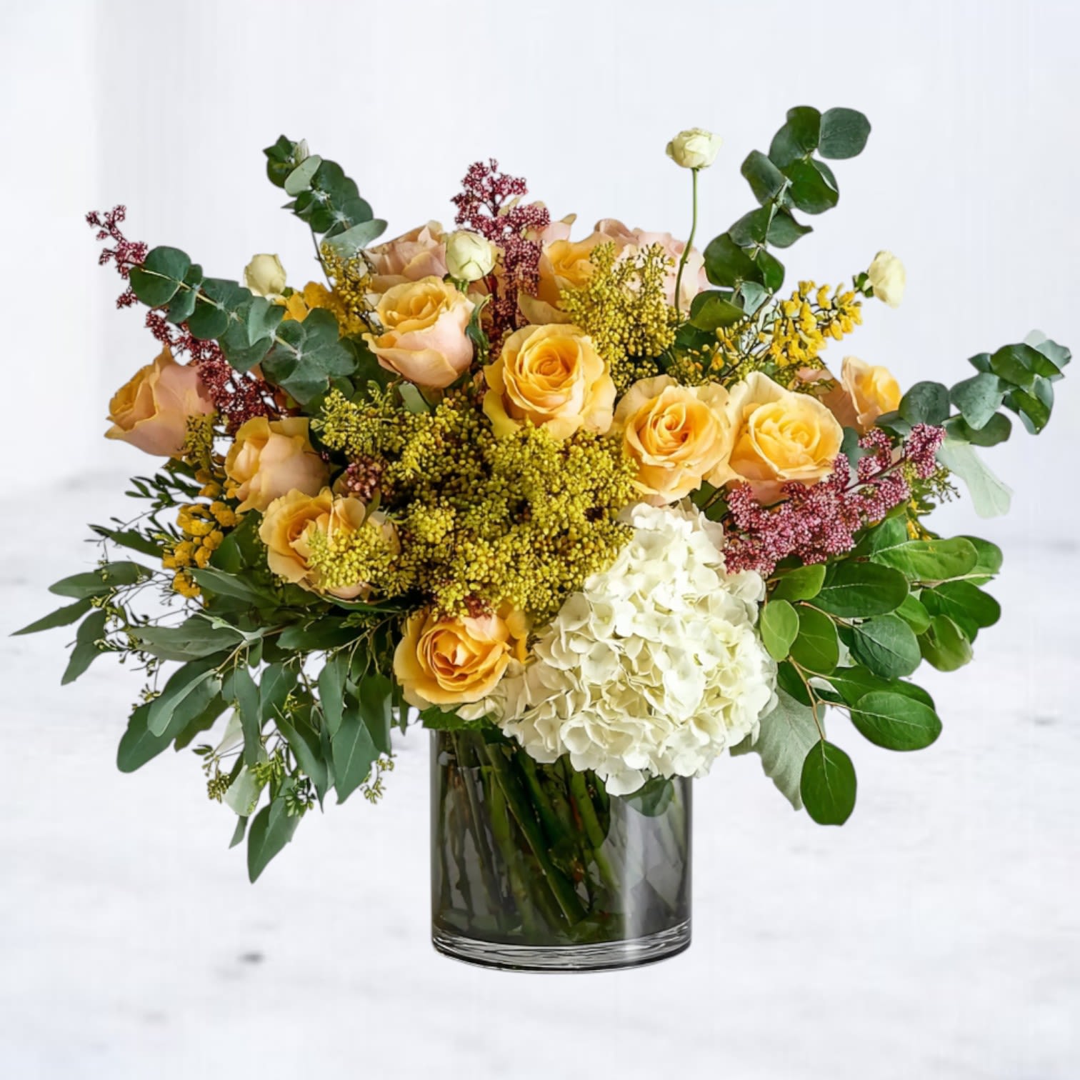 Wildwood Linen - The Wildwood Linen is a warm, textural blend of 24 yellow roses, ivory hydrangea, soft eucalyptus, and natural earth-toned accents — a modern, organic design that feels both refined and effortlessly inviting.  Designed in Whiskey Wallflower’s signature airy, layered style, this bouquet brings a touch of comfort and understated luxury to any space. Its neutral palette makes it a versatile choice for birthdays, heartfelt gestures, sympathy, housewarmings, or elevating your everyday décor.  Handcrafted with premium stems and delivered with care, the Golden Vale Arrangement is available for same-day flower delivery in Magnolia, The Woodlands, Conroe, Tomball, and surrounding Houston areas.