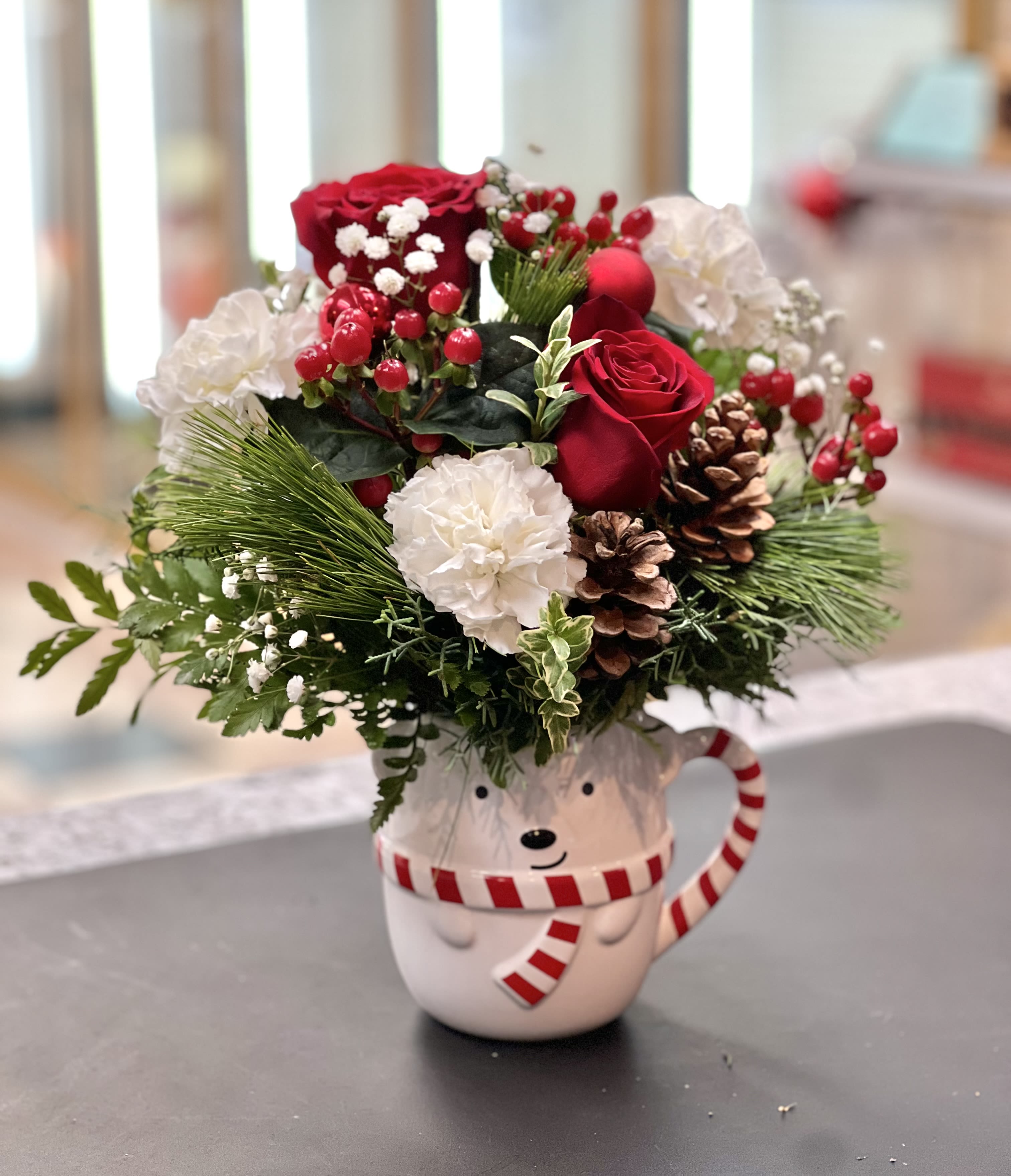 Christmas in a Bear Mug - This cheerful red and white bouquet in an adorable bear cup will surely light up the home of those who receive it with Christmas delight.