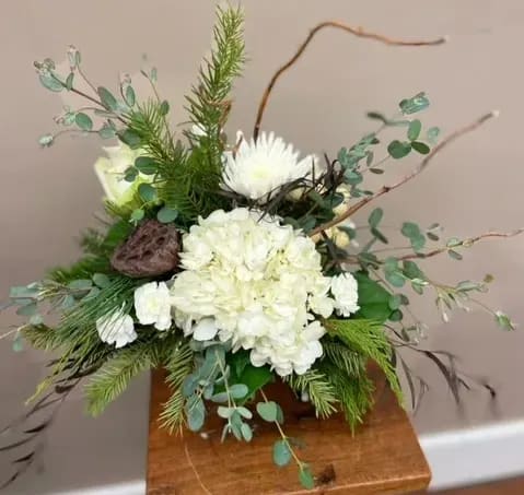 Woodland Winter - White flowers, curly willow, Lotus pods, and a mix of seasonal greenery make this a stunning arrangement.  Note: We make every arrangement as close to the picture as possible. There are times where we may have to make substitutions for the vase and the flowers based on our supply. 