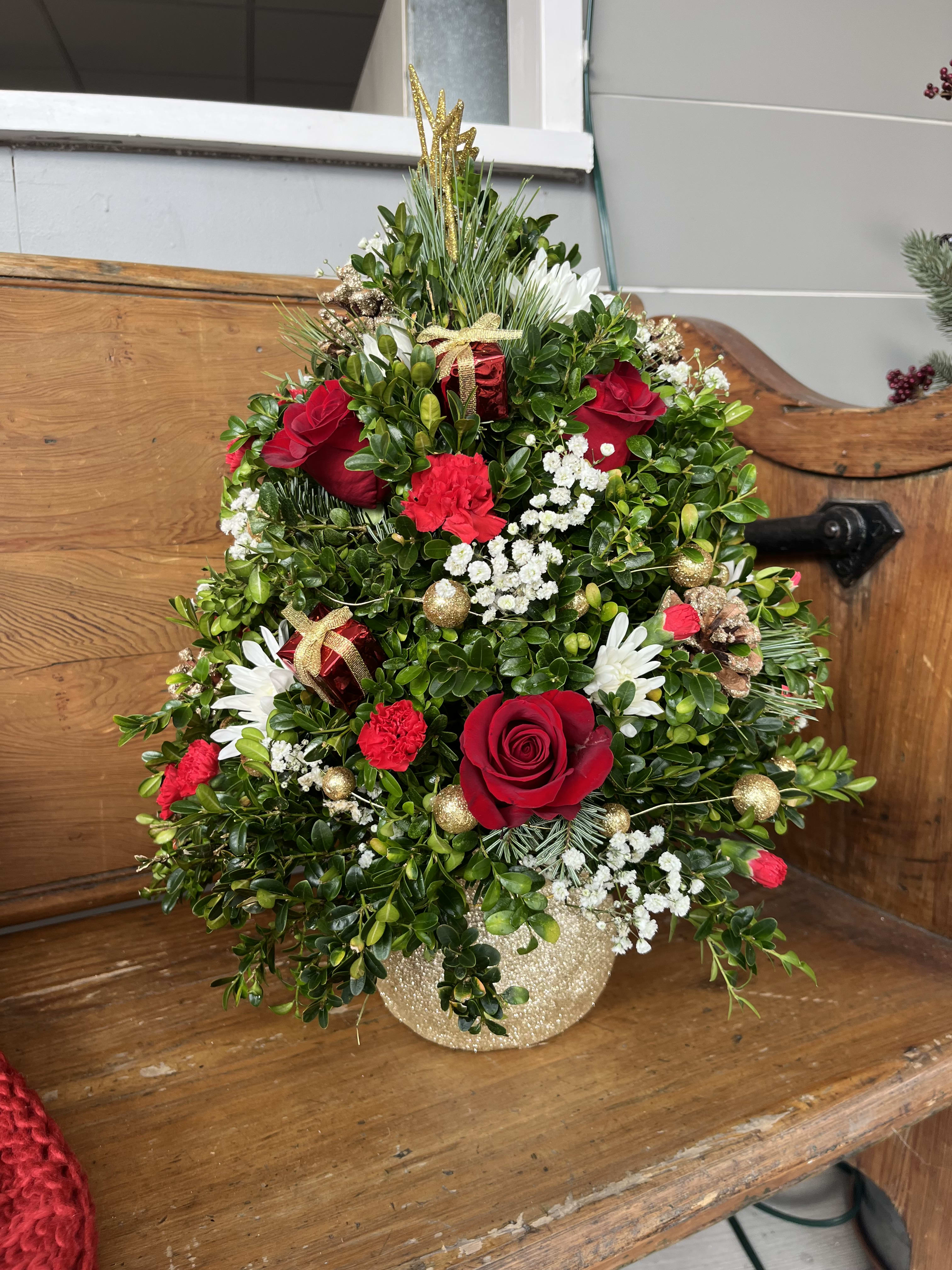 Holly Jolly Boxwood Tree - Boxwood tree designed in a dazzling gold Santa-sack keepsake, decorated to the 9's with pinecones, ornaments and fresh cut flowers. Topped with a golden star to tie it all together. 